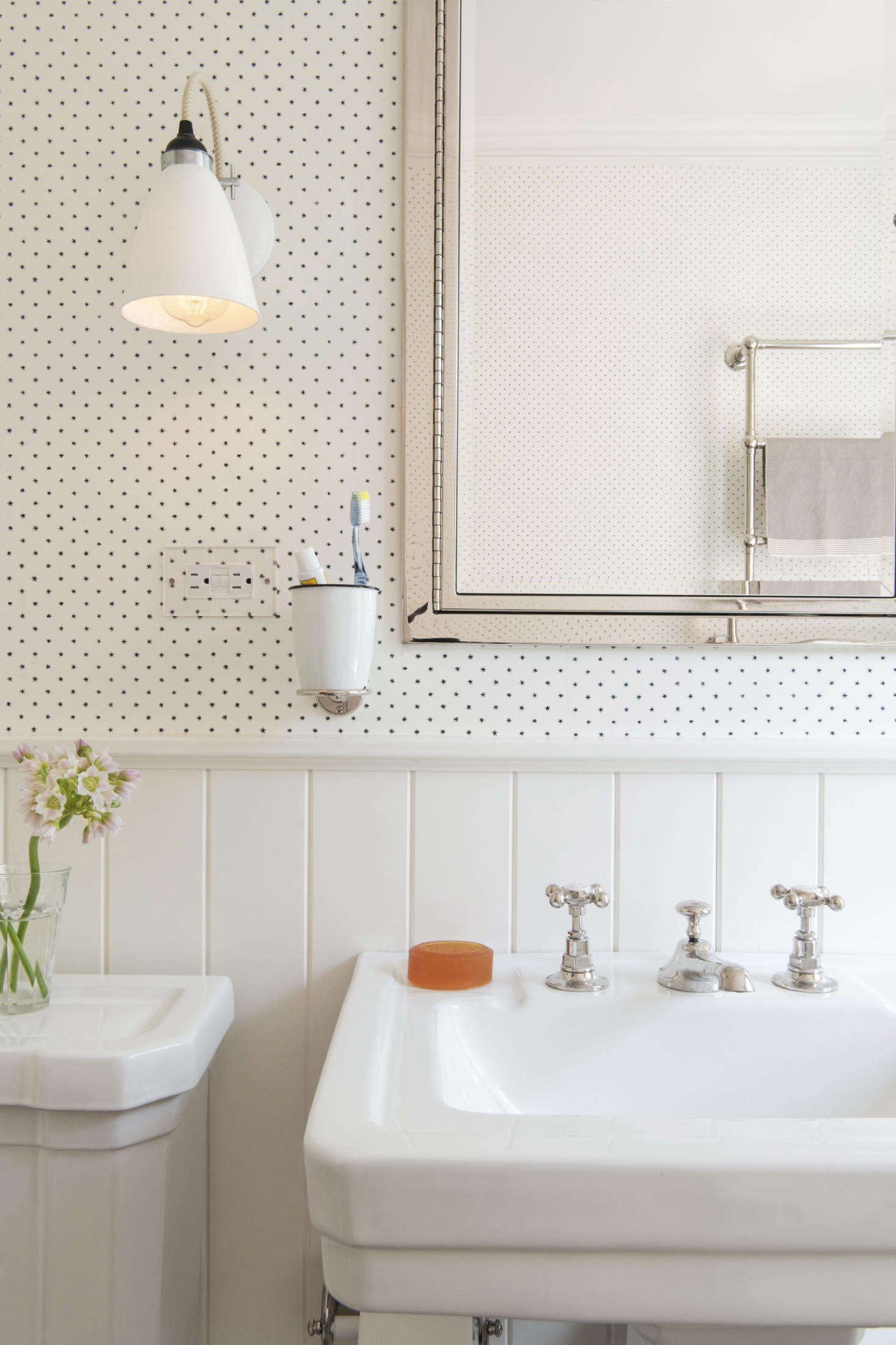 The room is papered with Lee, a tiny star pattern from Hinson. The pedestal sink is the Richmond from St. Thomas Creations. The nickel faucets are Barber Wilsons—part of the owners order placed in London.