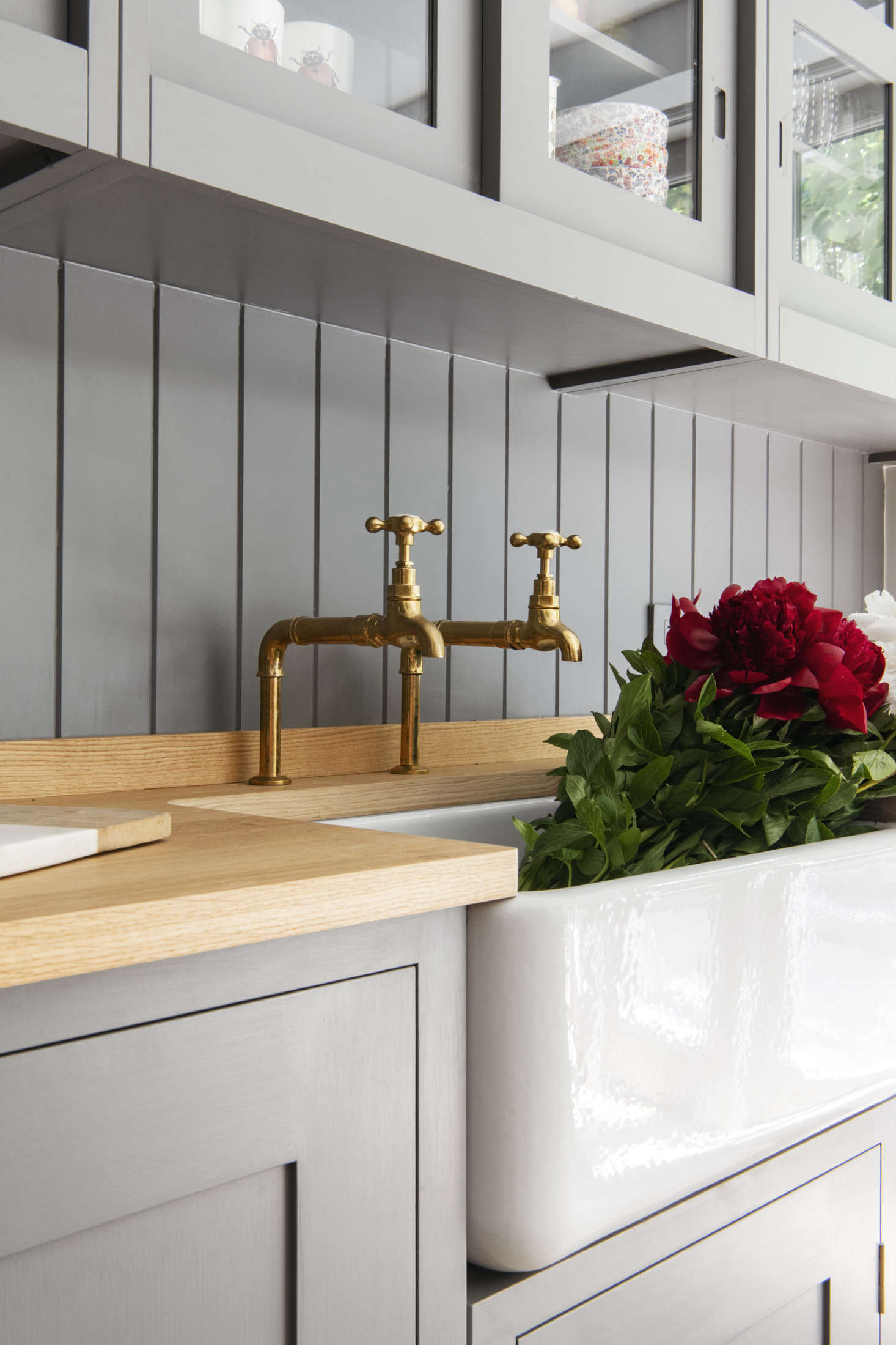 Barber Wilsons hot and cold taps in unlacquered brass and a Shaws Original farmhouse sink. The counter is Plain English oak butcher block.