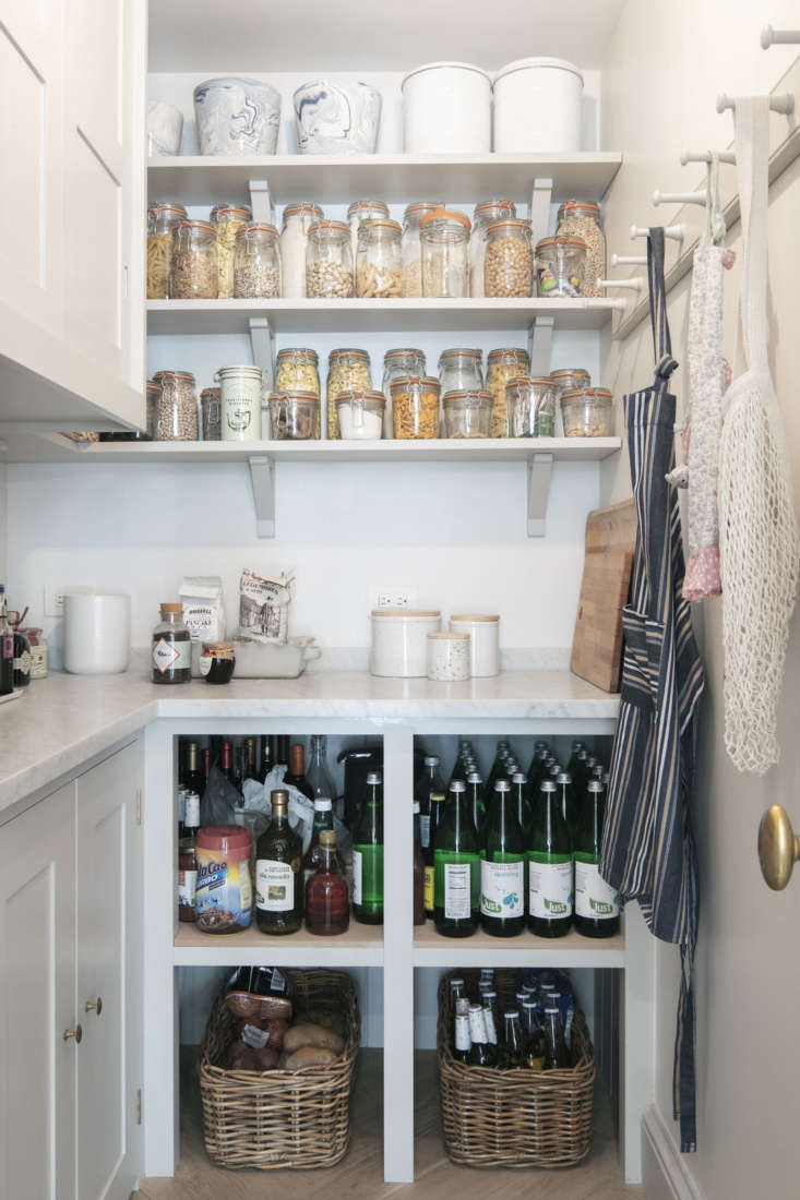 a proper pantry with a marble counter and a peg rail for shopping bags and apro 28