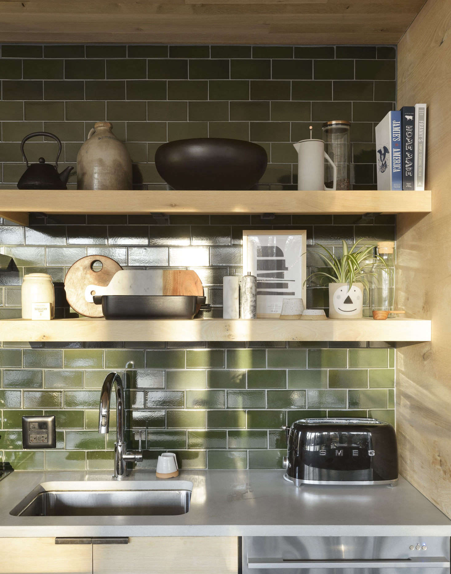 Sheena chose finishes and colors that reminded her of the outdoors. The green tiles are by Heath Ceramics, the faucet by Delta.