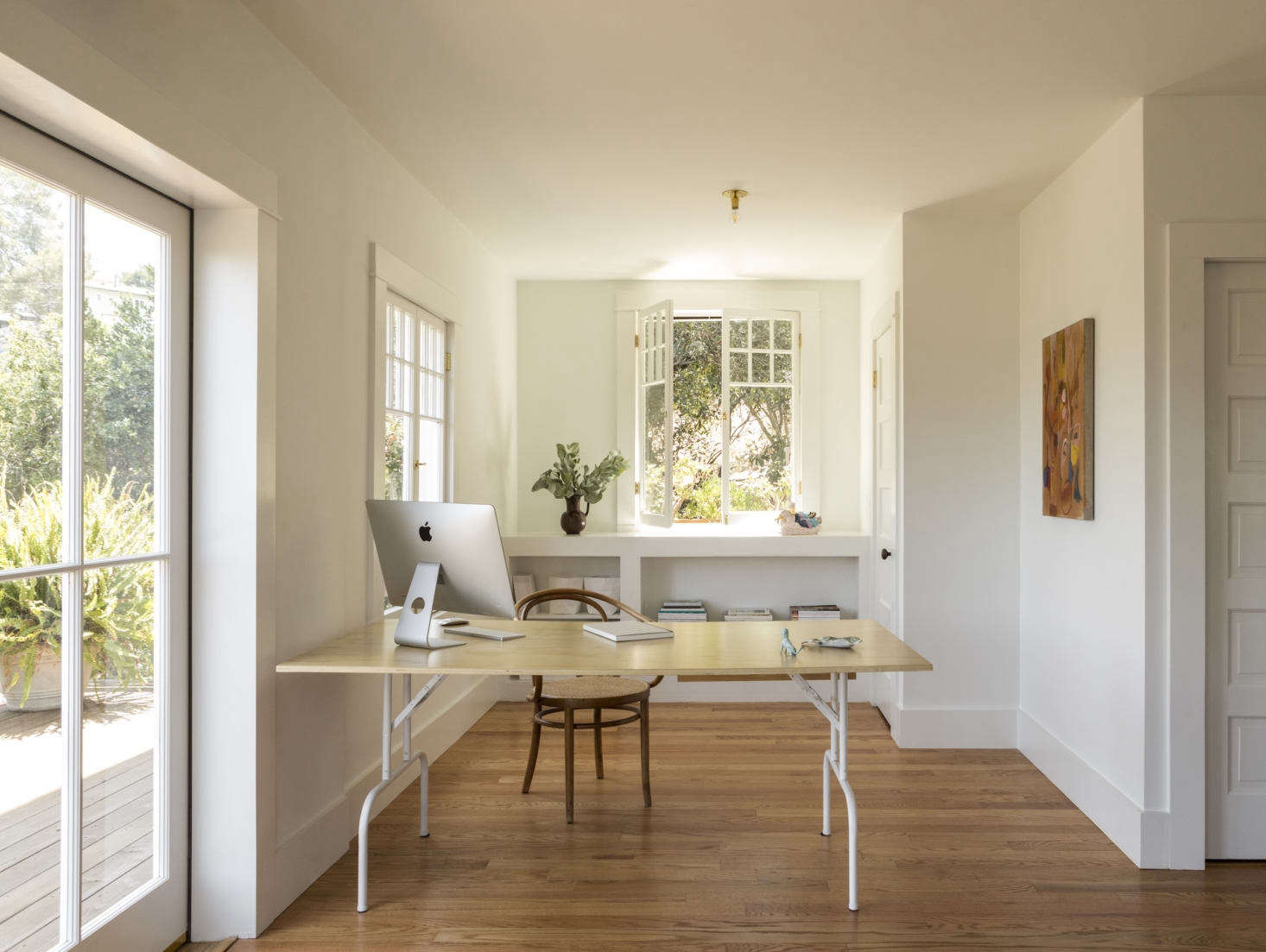 Sliding doors to a deck and multiple French windows add up to ample natural light in Kathleen Whitaker