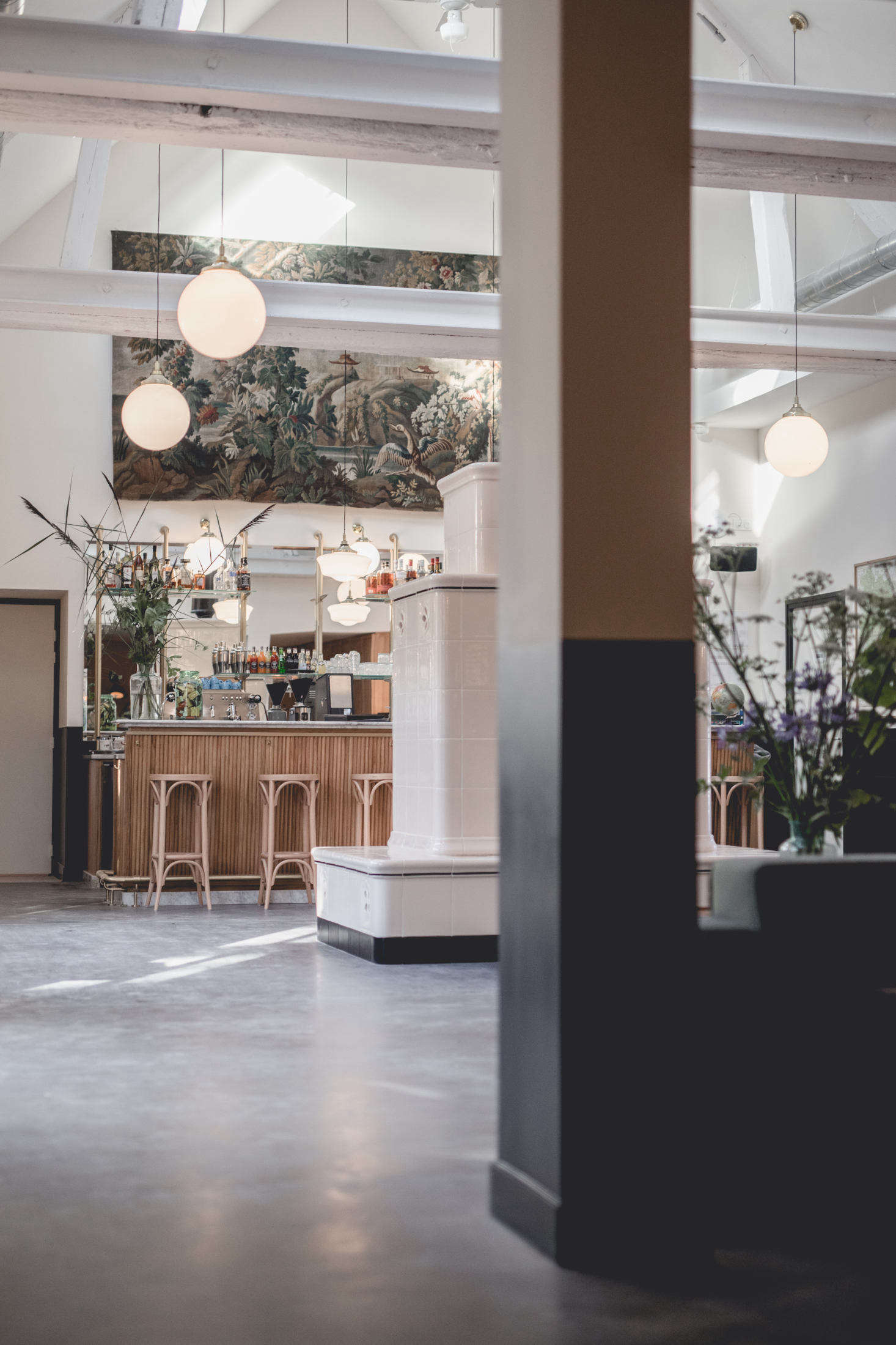 A tiled stove stands in front of the bar which is also the check-in/concierge desk.