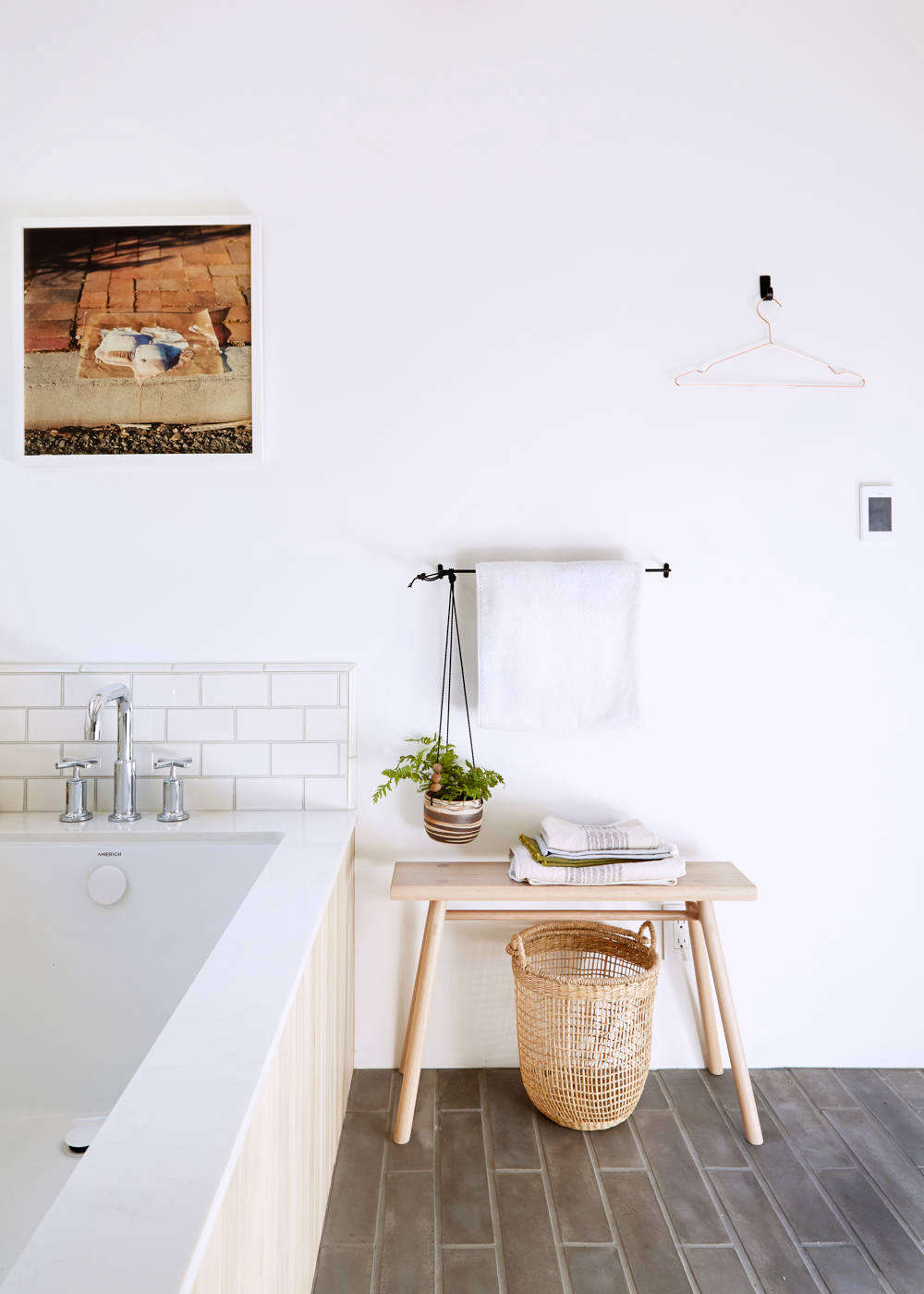 The hanging plant holder is from Crimson Horticultural Rarities in Oakland. The Fog Linen Towel Bar is from Atomic Garden in Oakland, and the West Slope Single Hook in oil-rubbed bronze is from Rejuvenation. The wood bench and the basket are from The Gardener in Berkeley, and the towels are from Coyuchi and Kontex. The framed “Neapolitan” photo is by Katie herself.