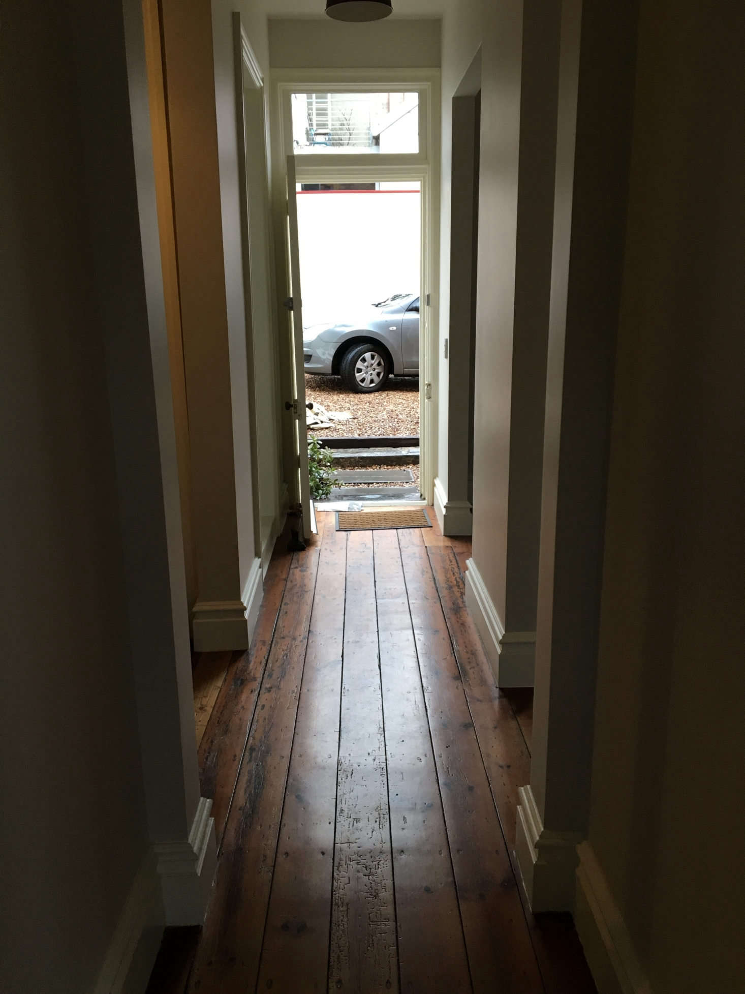 The rooms radiated off a central hall leading to the carport out back.