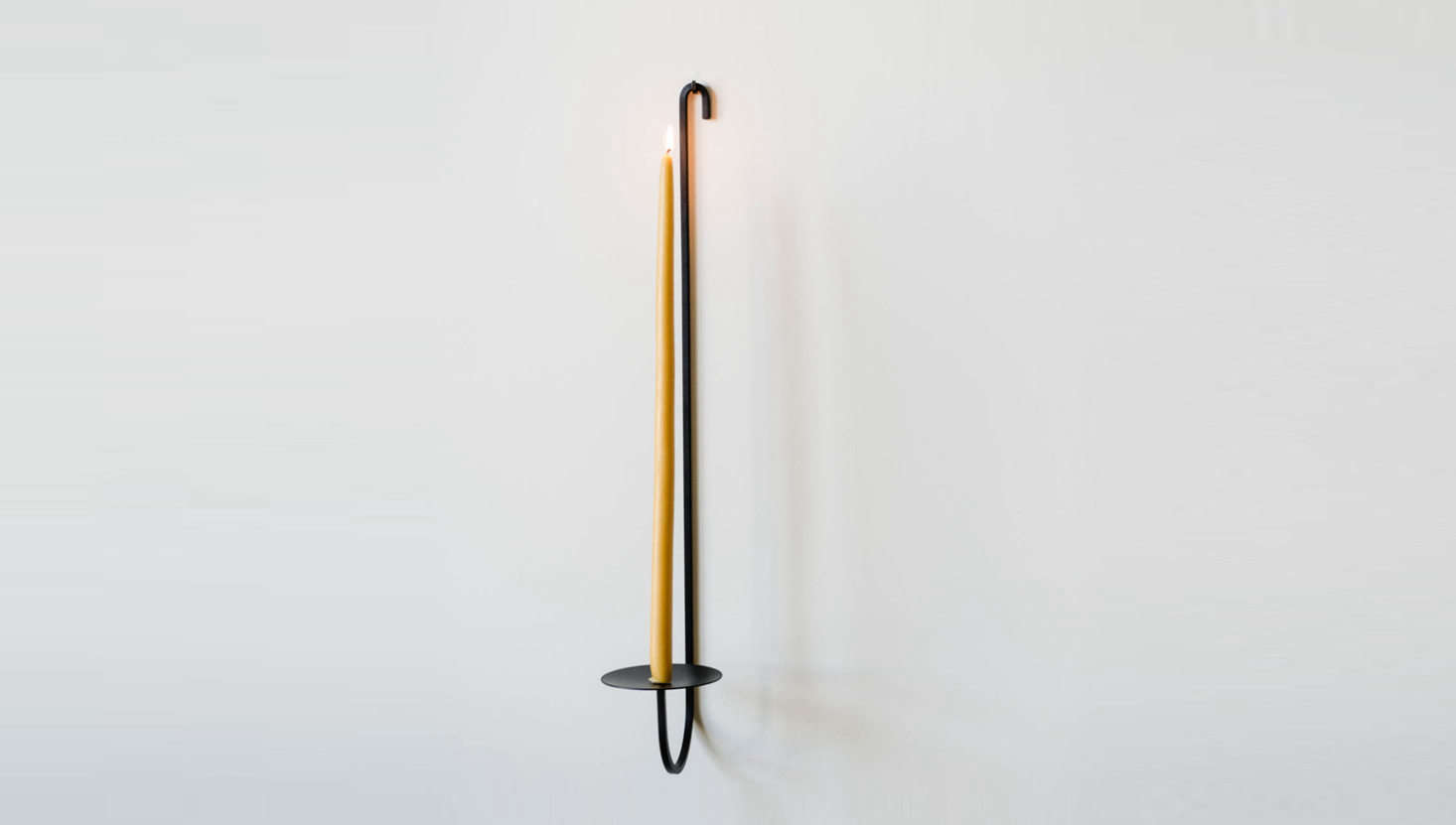 The long, lithe Iron Single Arm Candle Holder comes with an iron hanging nail; $50.90 from June Home Supply, or $50 from Fredericks and Mae.