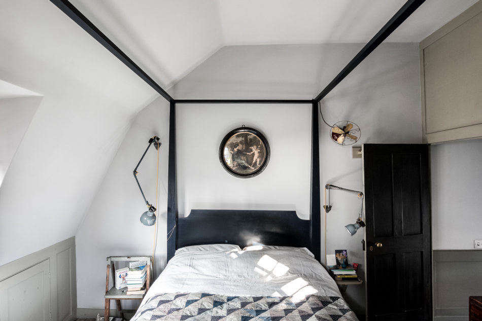 A bedroom on the top floor. Note the artful placement of the bedside sconces.