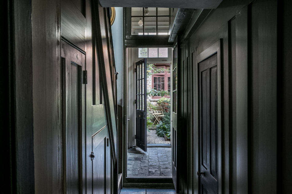 A narrow hall leads to a small garden in the back of the house.