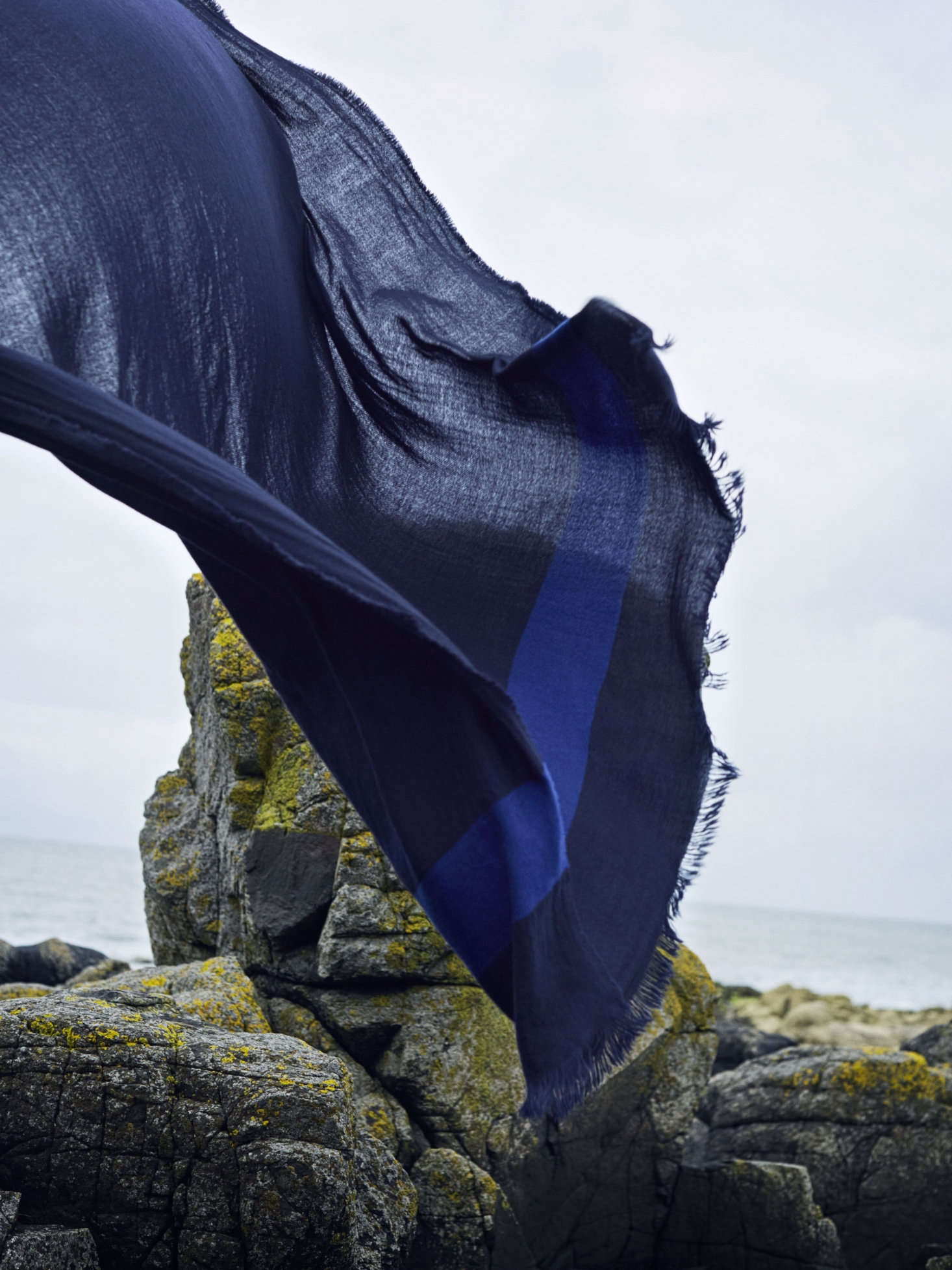 The lightweight Voyage Washed Cashmere Travel Blanket, shown in Marine, can be used as both a shawl or a blanket; £490.