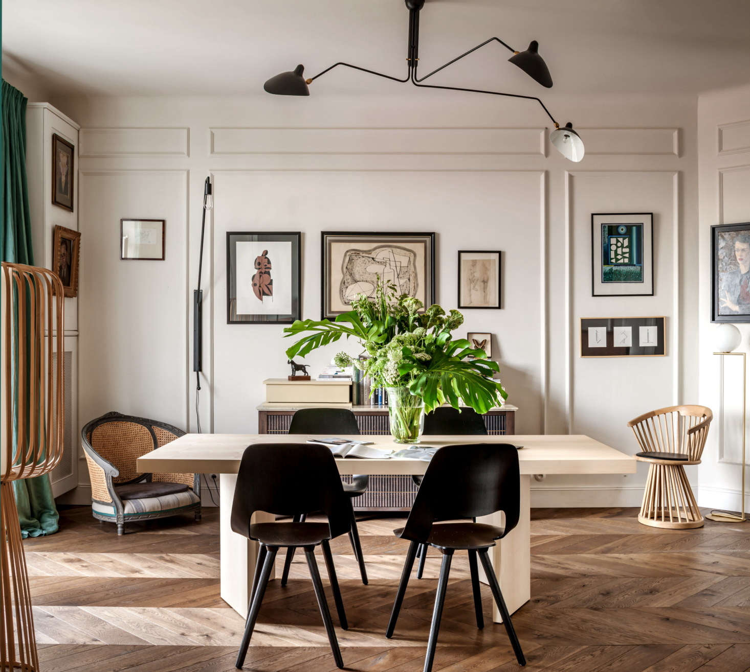Chrapka and her team designed the dining table, flanked by plywood Vitra chairs, and the sideboard. Much of the art in this room is from eBay. Note the antique armchair, at left, that was cleverly converted into a dog bed.