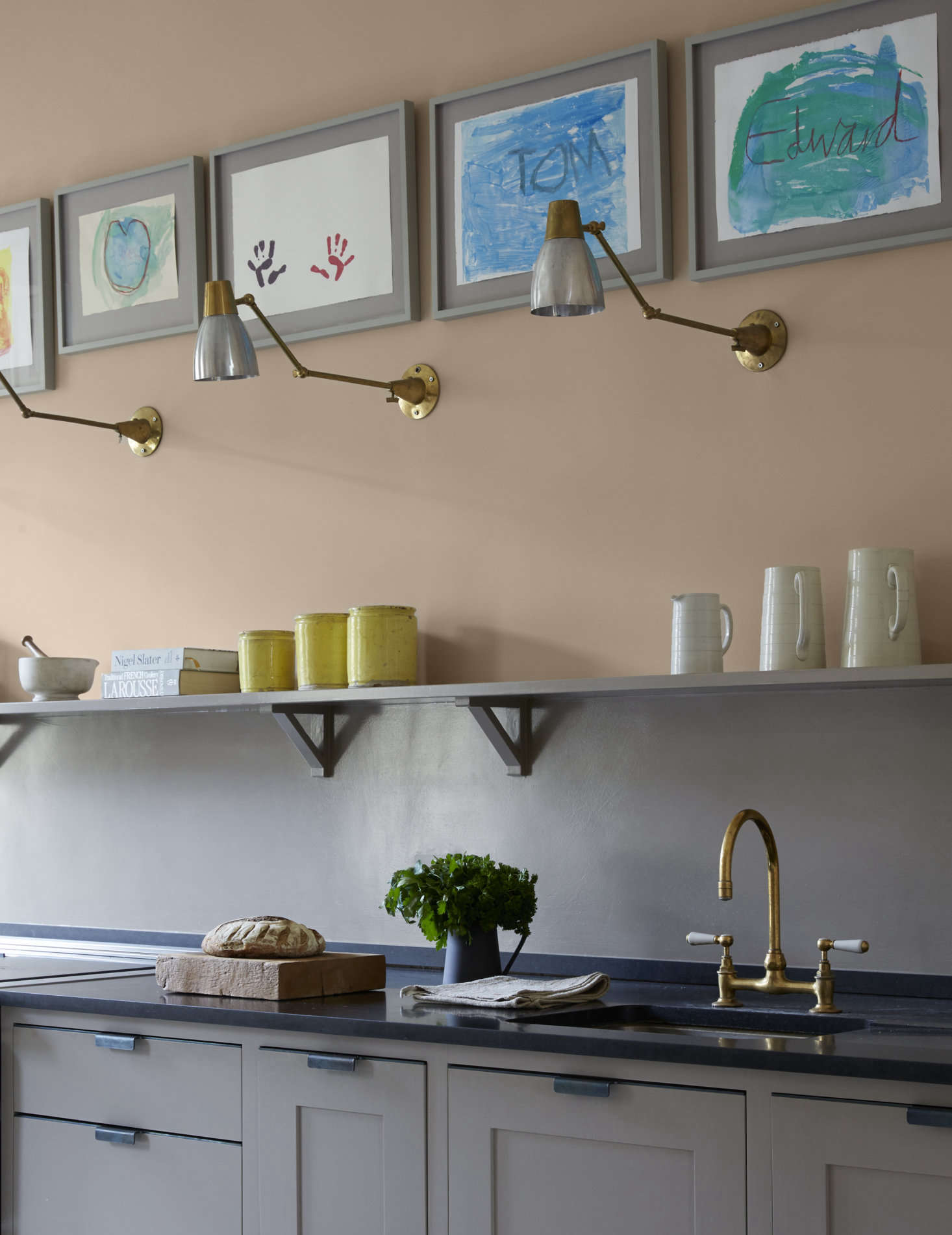 Harding led an art workshop with the Gilpin kids and hung the results high in a row over the sink counter. 