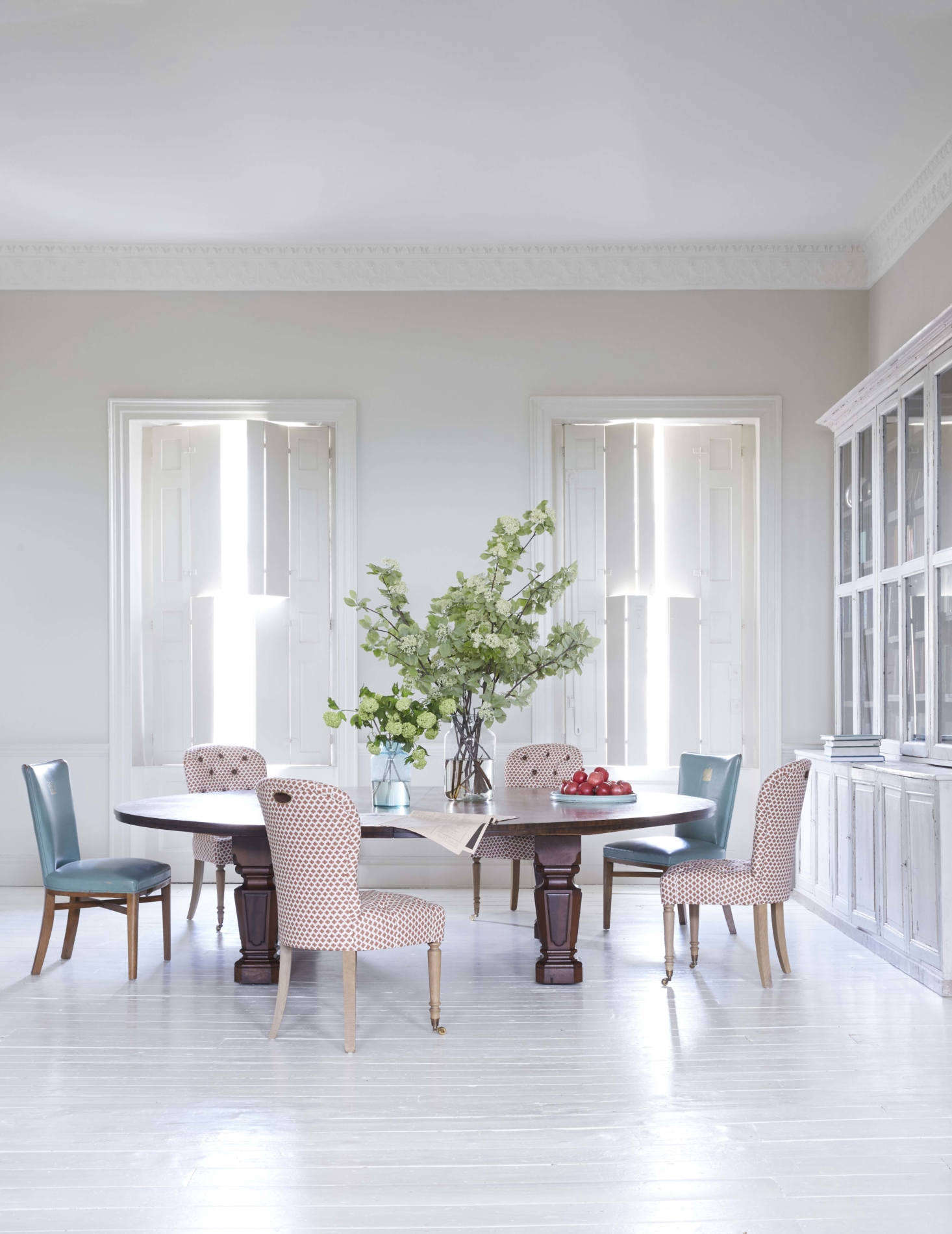 The rear of the room is used as a dining area. The nine-foot Holland & Sons mahogany table dates to the 60s and Howe, says, was probably made for a government building or library. Harding chose to go rug-free here to preserve the sense of space and to 