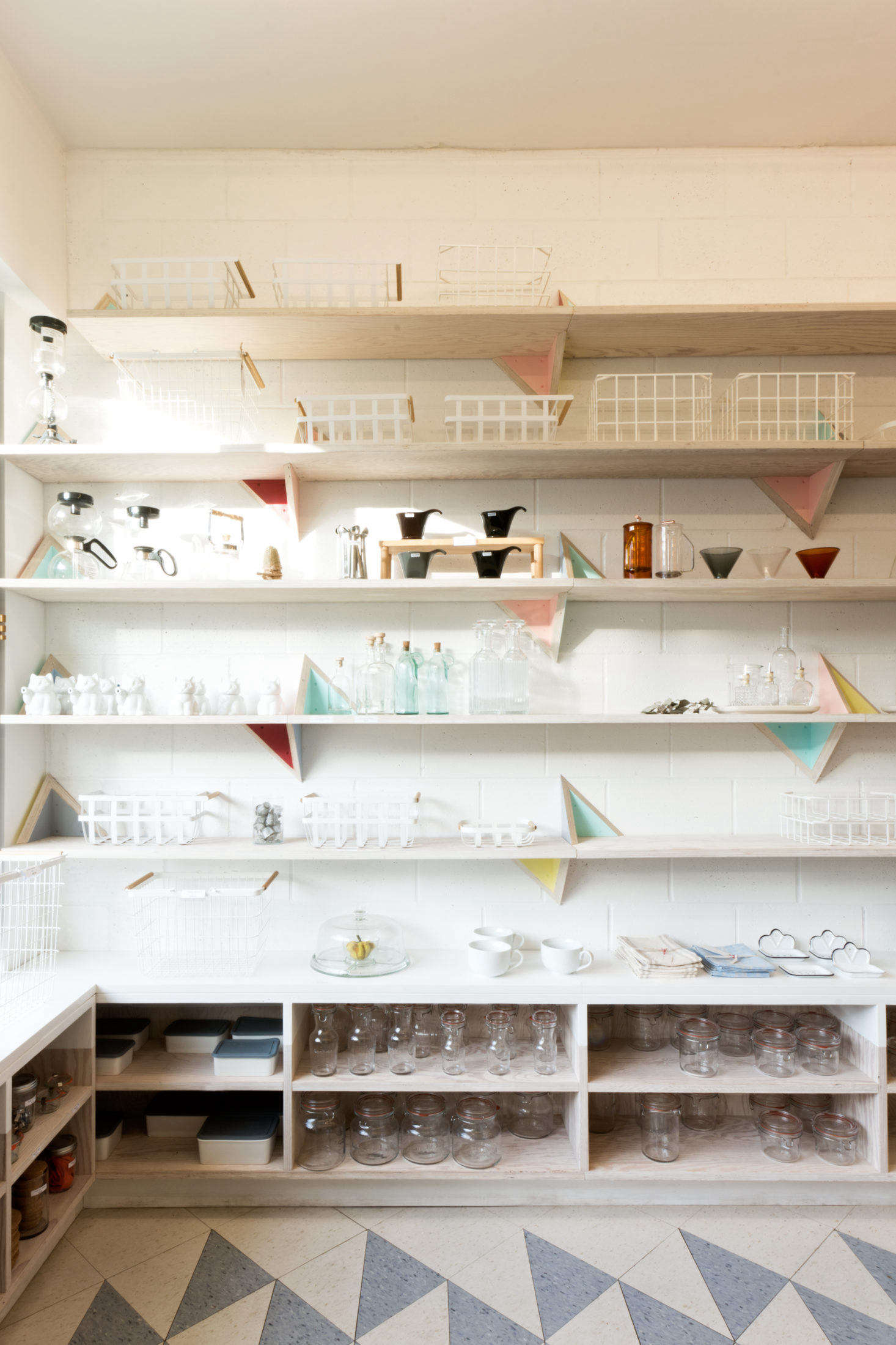 A curated selection of non-plastic kitchen essentials is displayed on regionally sourced Douglas fir plywood shelving.