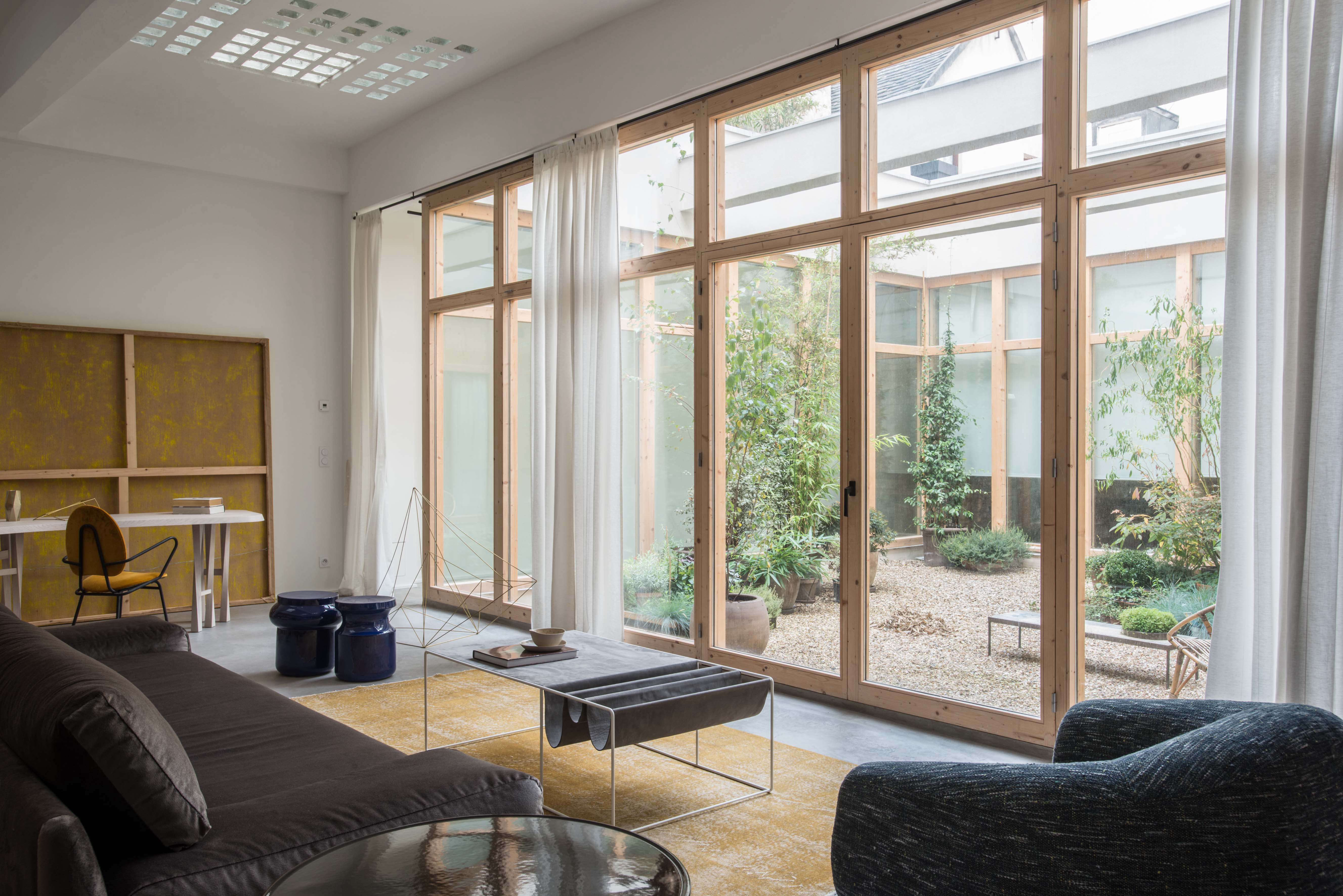 a view of the room that looks out onto a central courtyard created by the archi 18