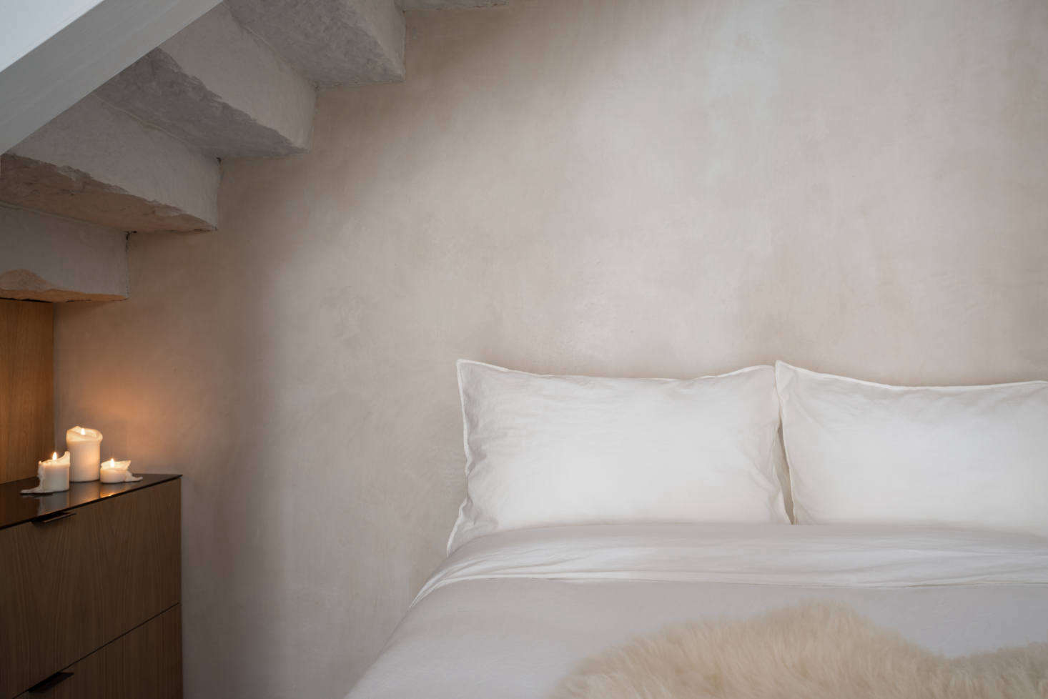 The bed is tucked under stairs that once led to the blacksmith