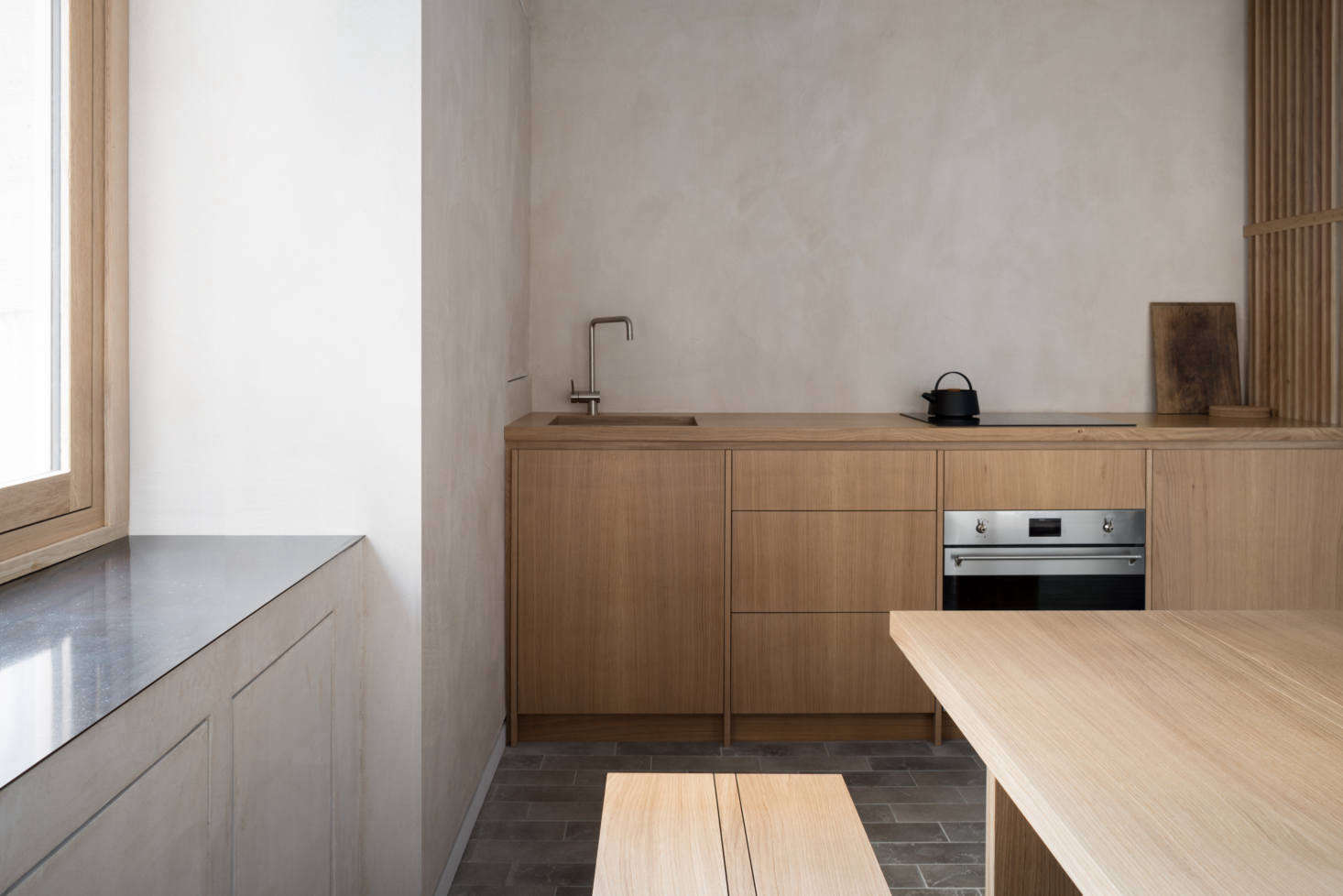The streamlined window frames are also oak, as is the bespoke kitchen and the slatted screens, a collaboration between Namon and Richard Anstice of 56 North.