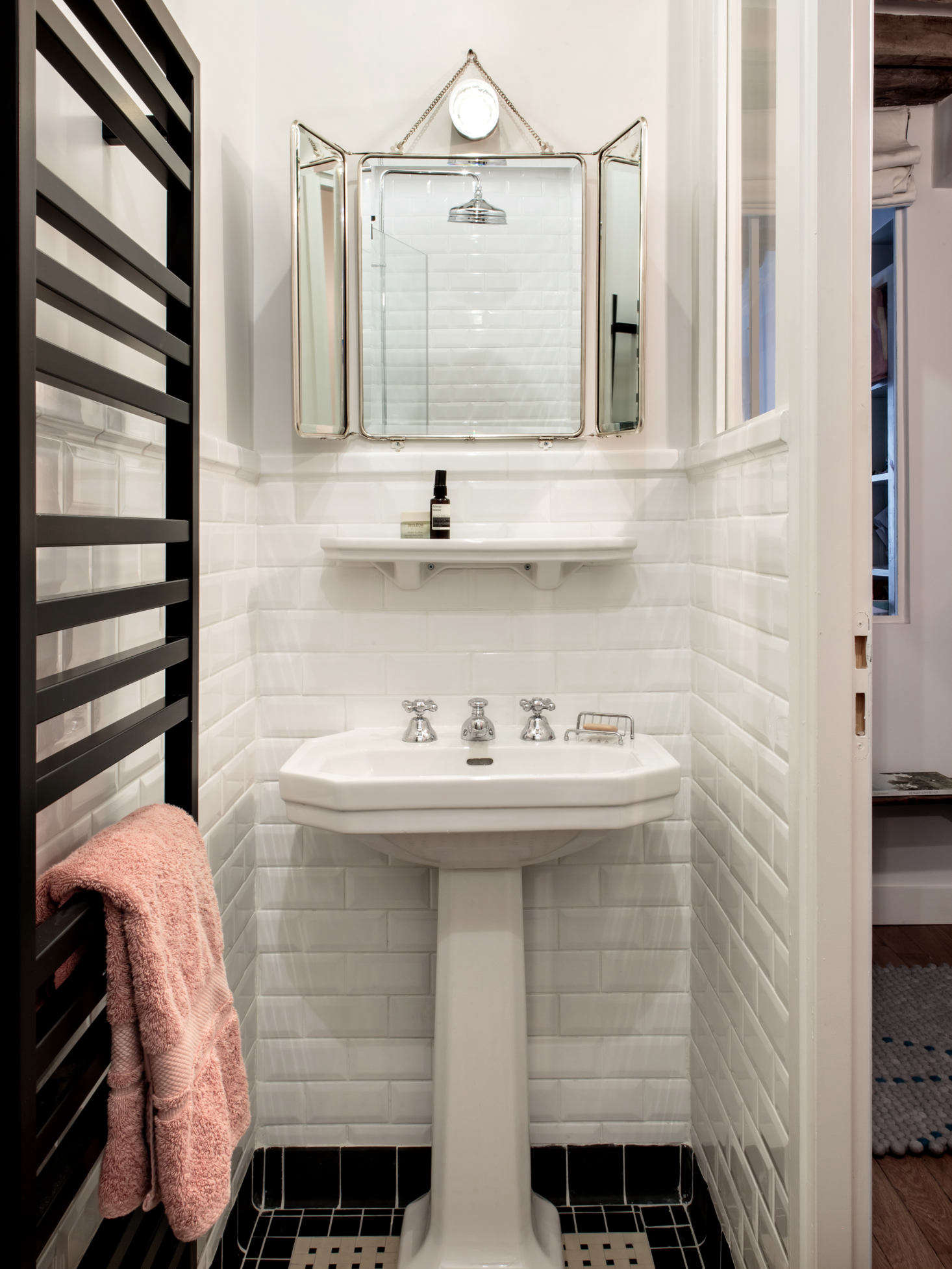 The space formerly occupied by the kitchen was converted into a second metro-tiled bathroom, this one with a towel warmer and shower. To see the apartment in its previous incarnation, go to The Socialite Family.