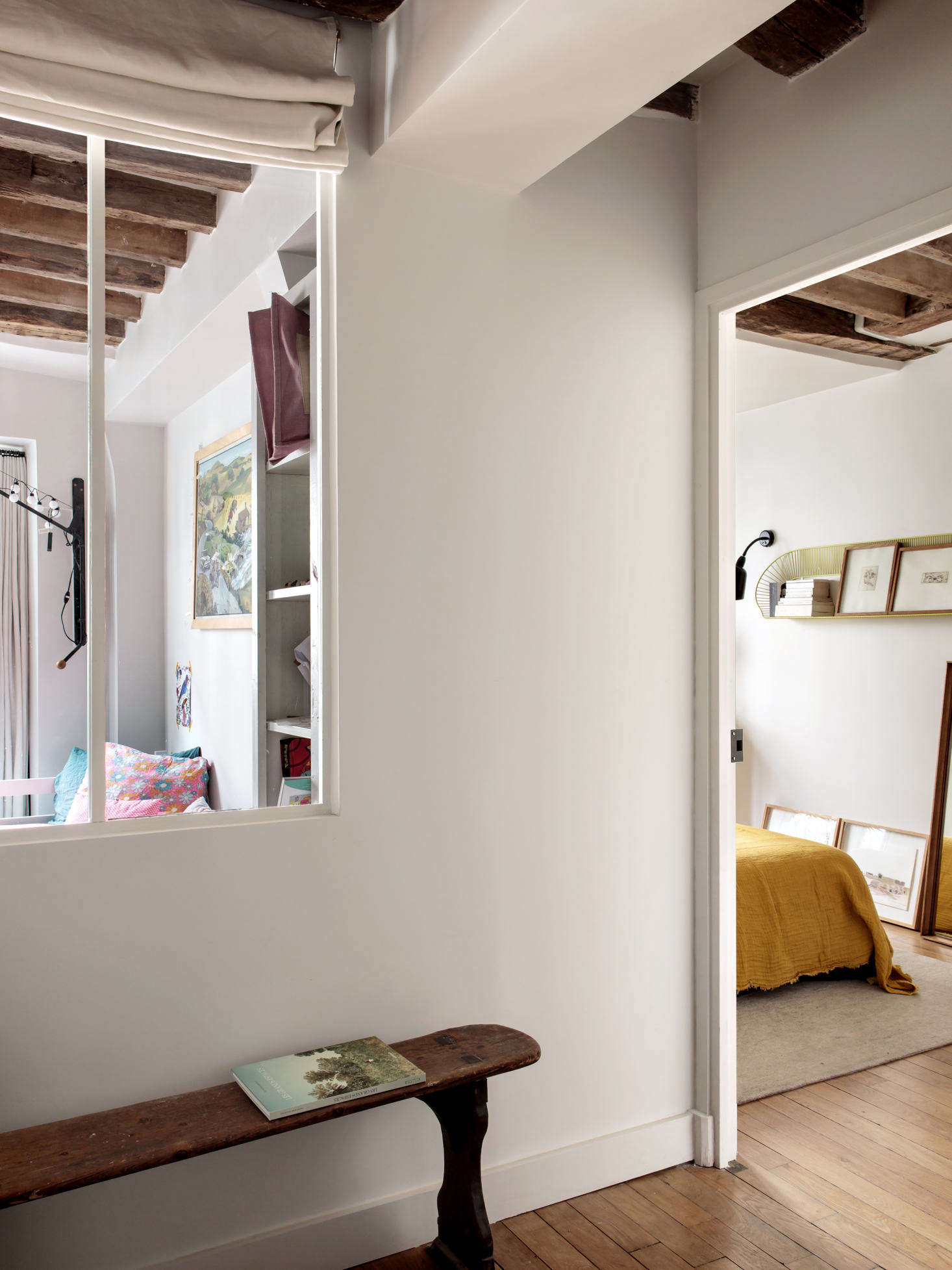 The architect also introduced interior windows in the bedroom hallway. The antique bench came out of a school.