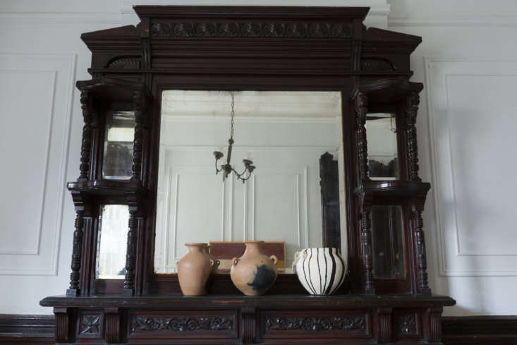  on the mantel are three terra cotta pots, collected on avent deleon&# 19