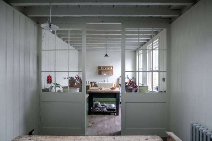 a more pulled back view into the kitchen. the sash windows, exposed ceiling joi 18