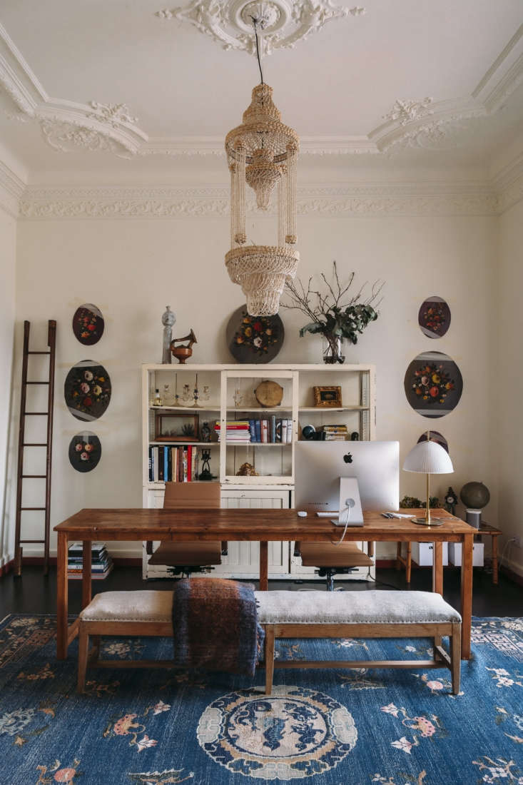 off the entry, a work table stands on a chinese art deco rug under a beaded cha 17