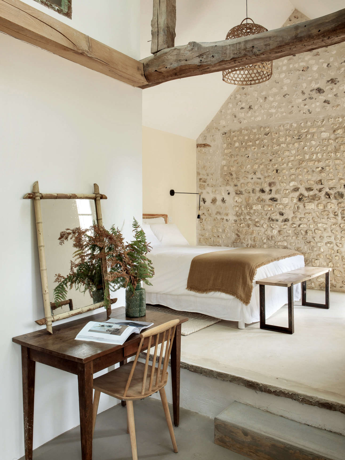 The annex has a farmhouse vibe. To create this suite, Feilders had the attic floor removed to expose the beams and cathedral ceiling.