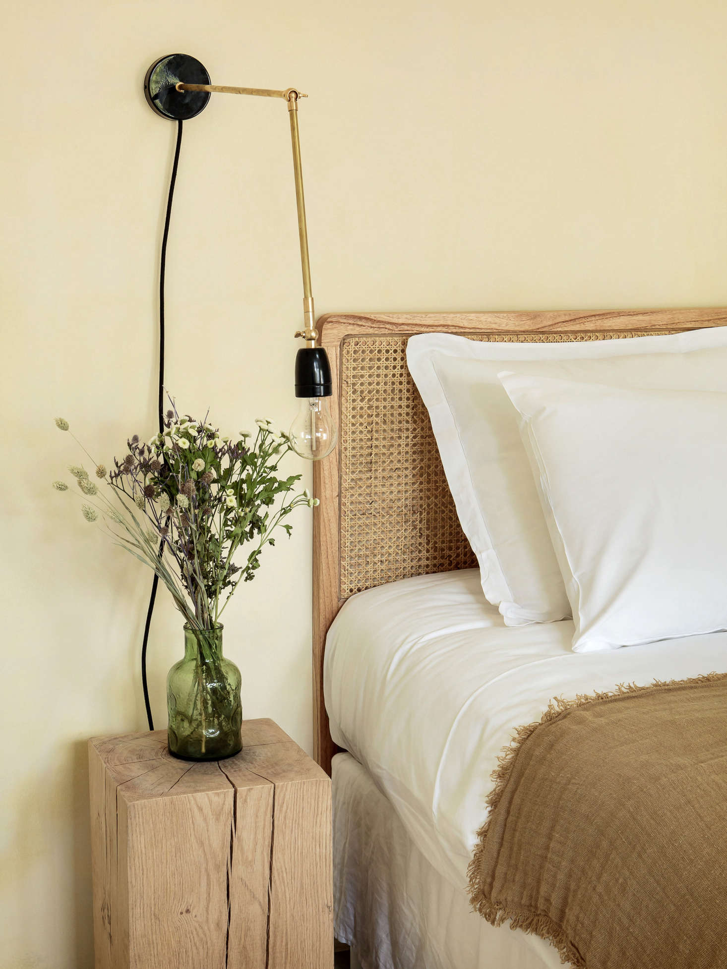 A rattan headboard and Porcelain and Brass Sconce from Zangra.