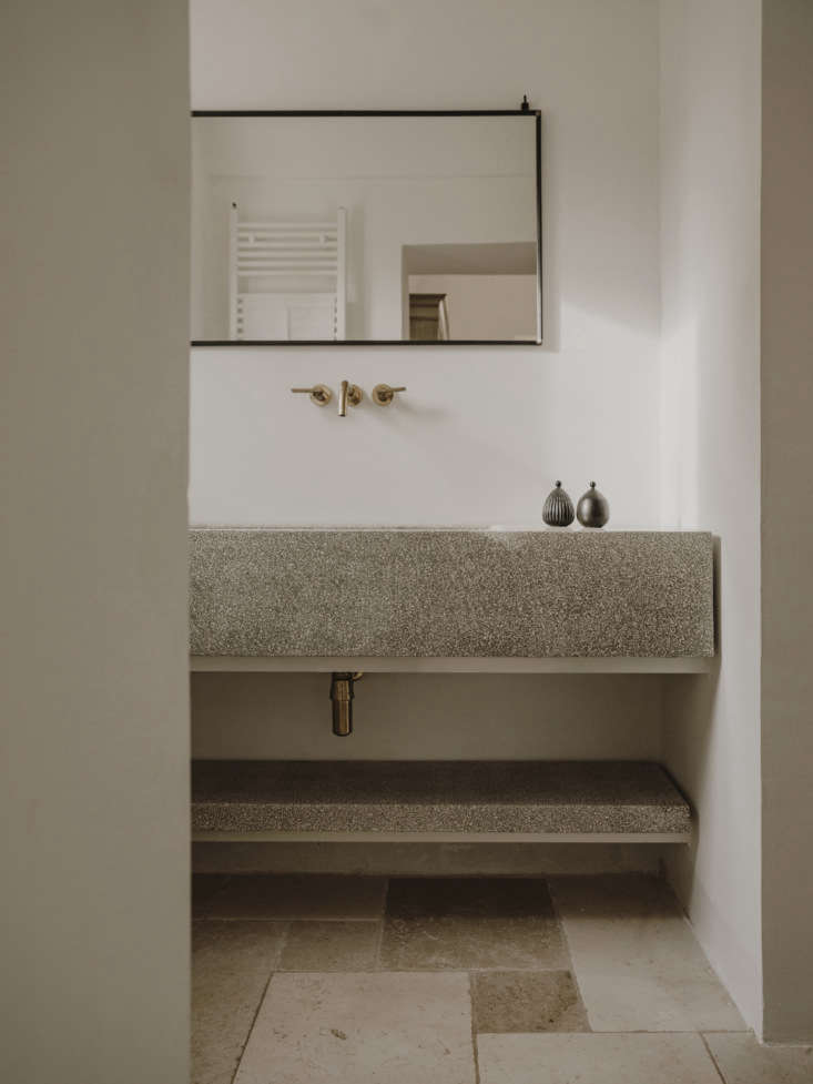 the bathrooms have custom concrete vanities that echo the kitchen counters. 28