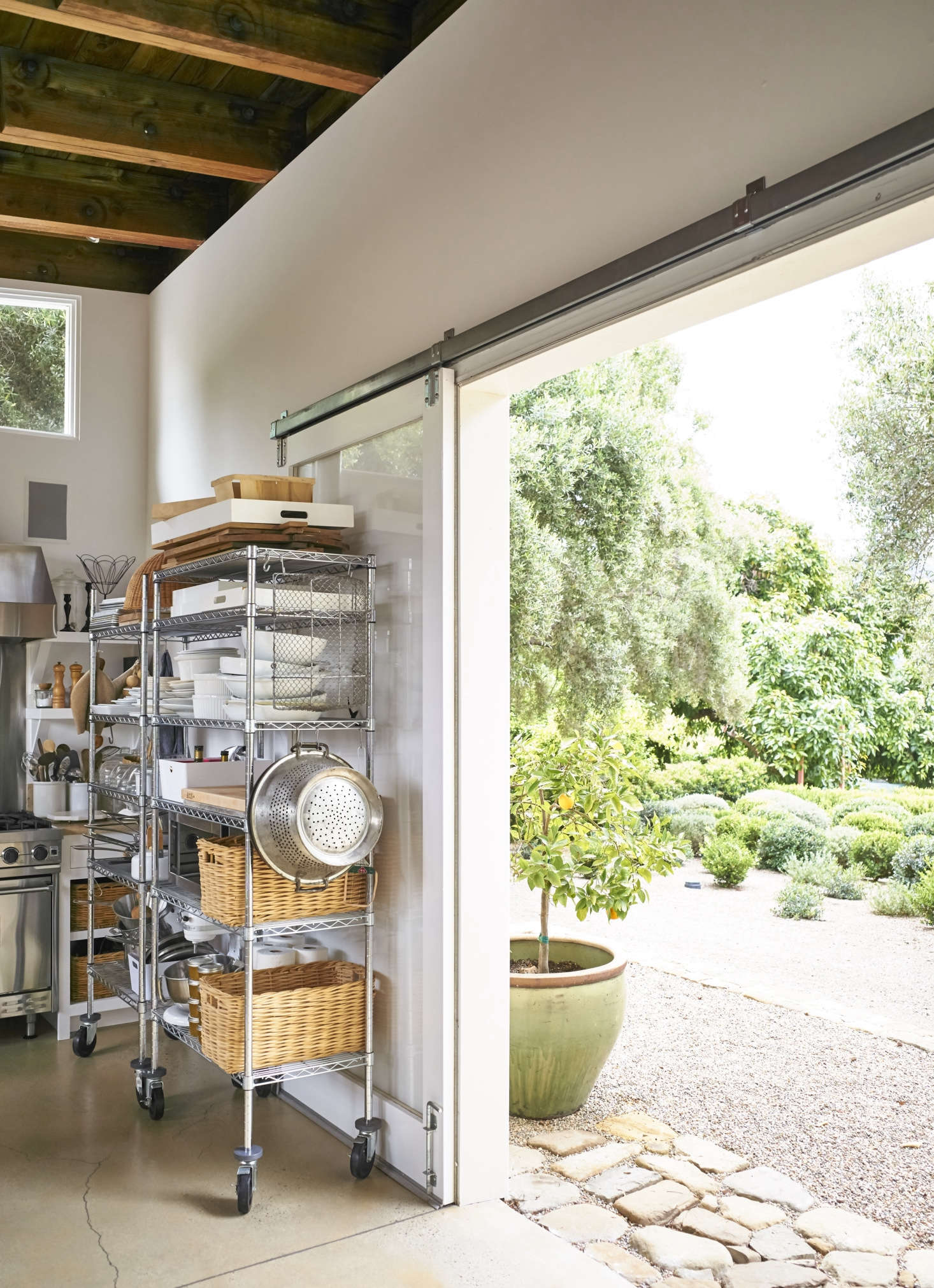 Restaurant-style metal shelves on casters add significant storage for props, bakeware, and utensils, but can be rolled away to clear the room for a shot. The kitchen opens directly onto Pearson