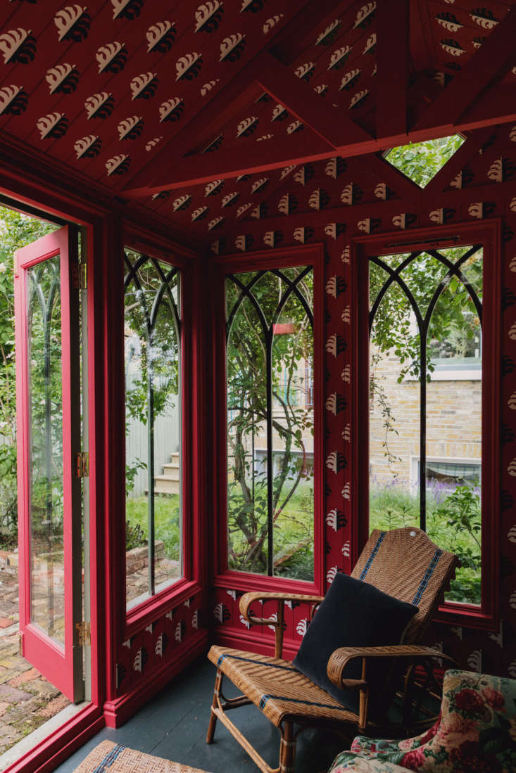 hand painted red patterned walls in the garden pavilion of designer of the mome 17