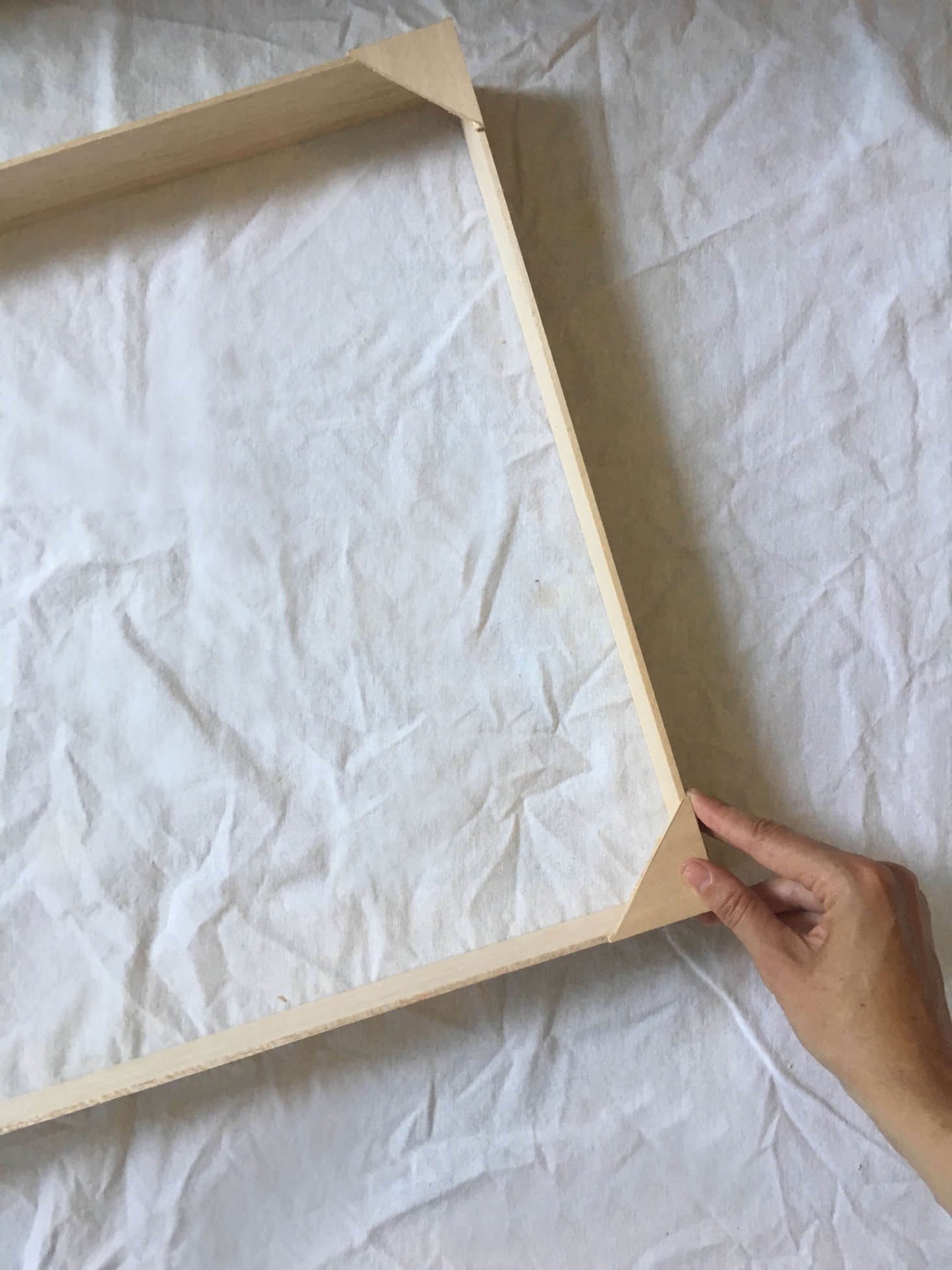 Holding the frame in place while it dries.