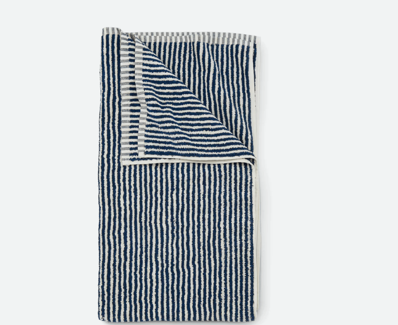 The Striped Beach Towel from Huckberry is available in navy/cream (shown above) or spring green/cream; $.98.
