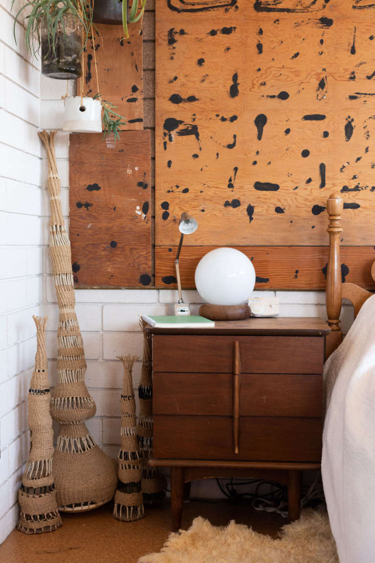 a trio of woven works anchors a corner of her bedroom. the pollock esque wall b 19