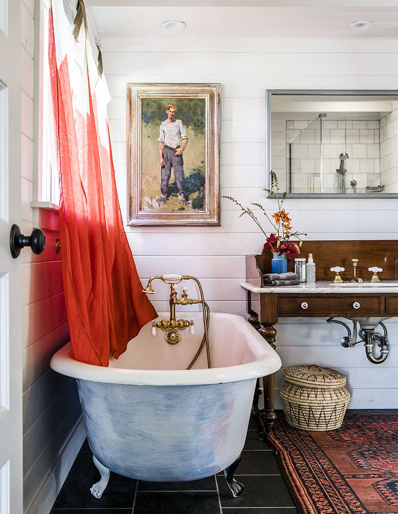 Also from Second Use: the circa-s tub in the primary bath. A pair of signal flags found in Provincetown make charming curtains.