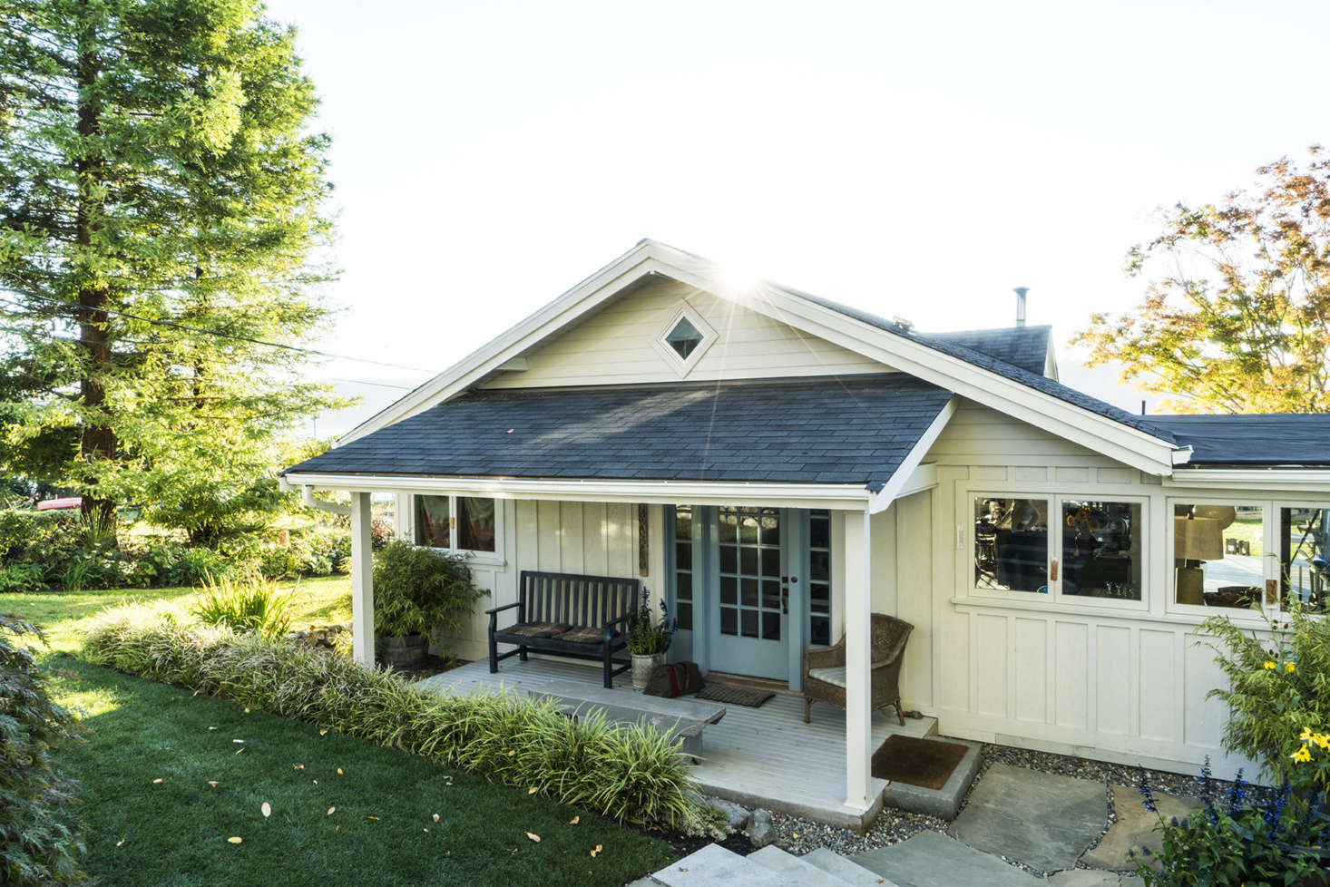 A blue front door references the waterfront views just behind the house.