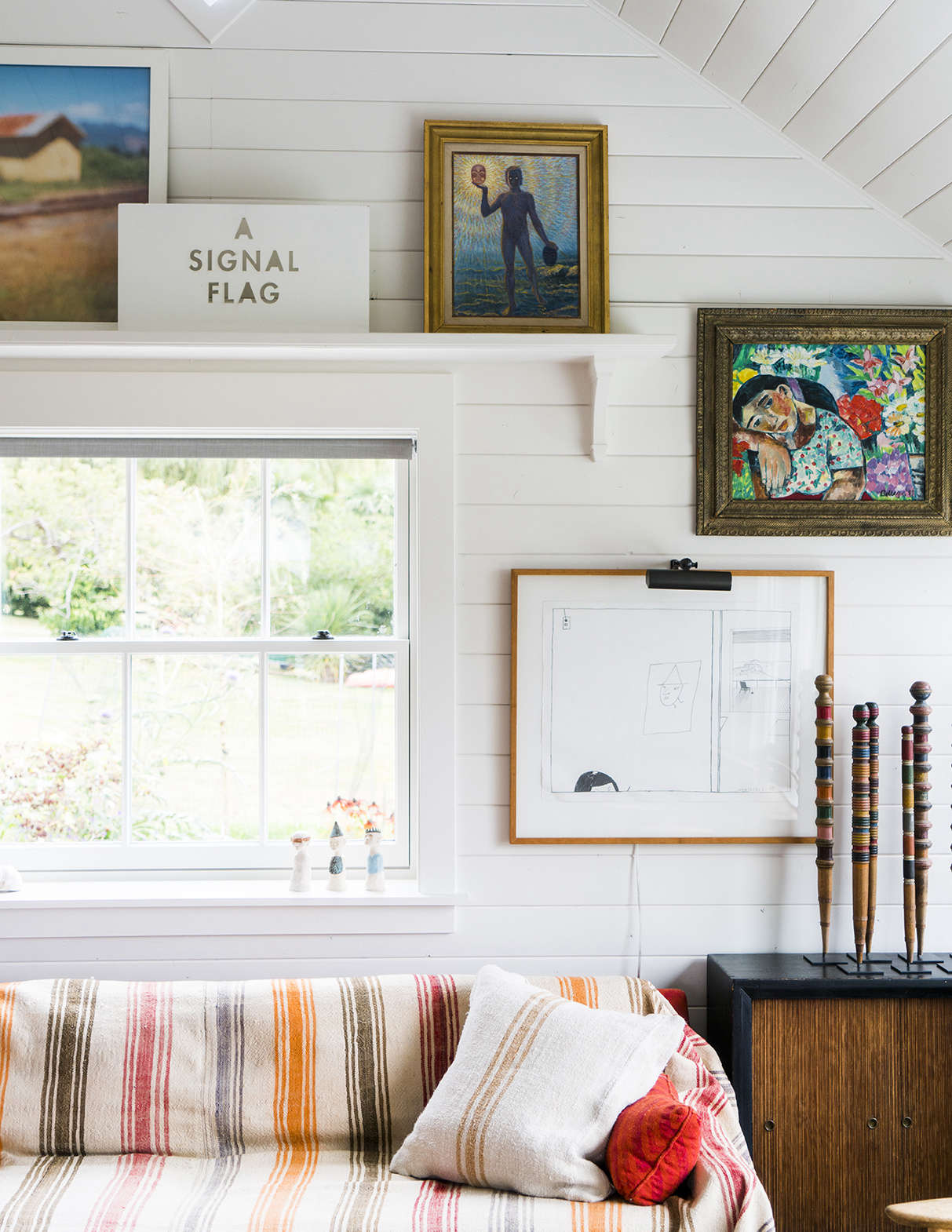 The cedar-paneled walls in every room were painted a soft white for cohesiveness.