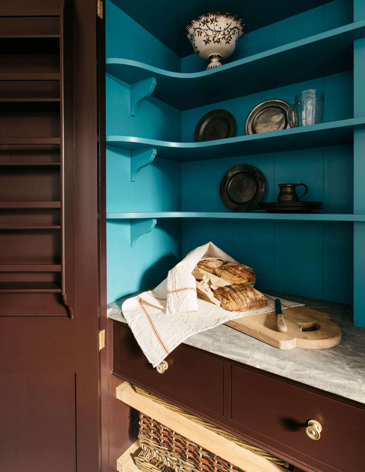 Slide-out baskets, tucked in the lower level of the cupboard, are ideal for fruit and veg storage.