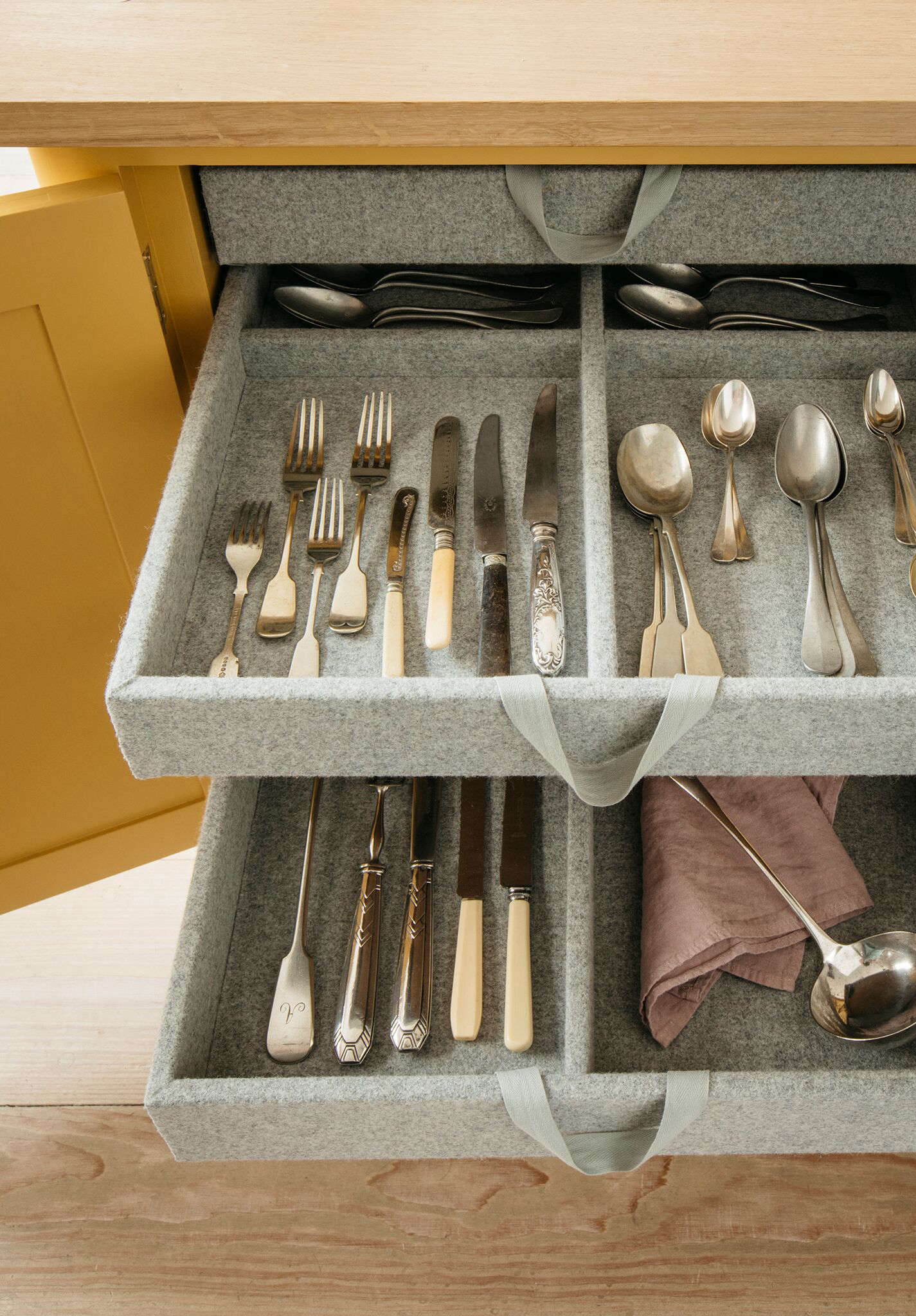 A cutlery drawer is tucked into the kitchen island.