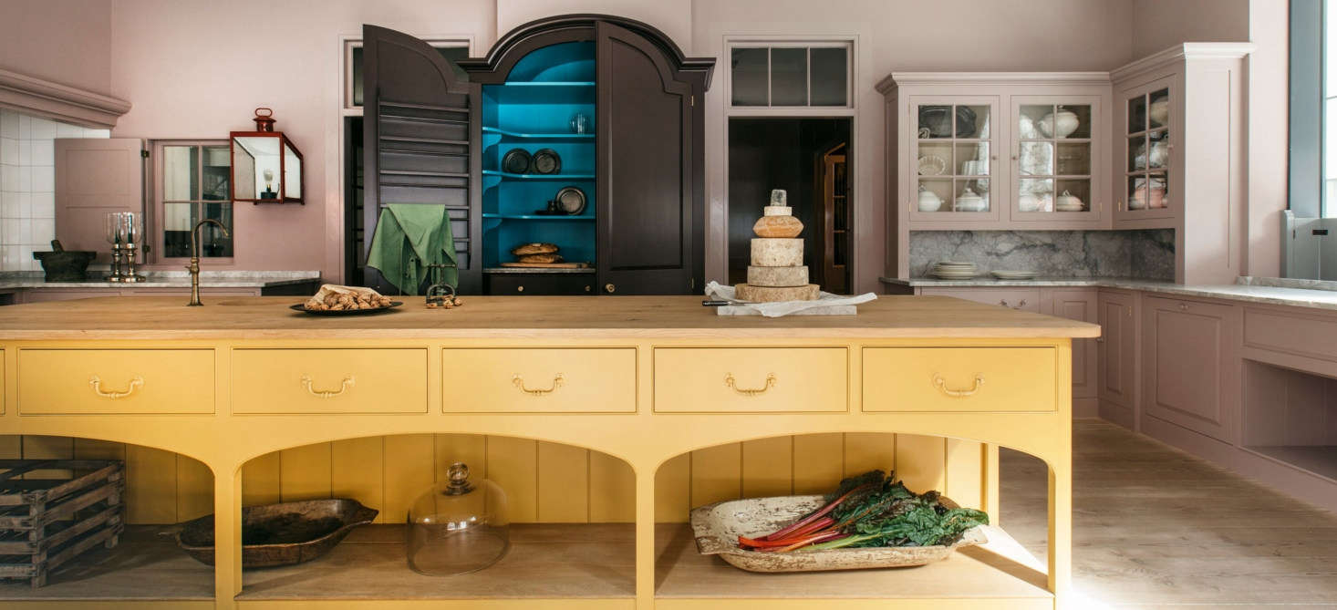 The Plain English Marylebone showroom in London; the kitchen island is painted in murky gold Nicotine.