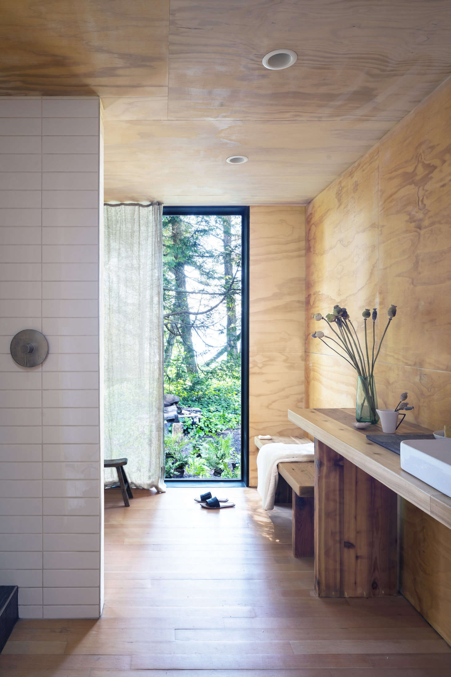 Wittman Estes reused and repurposed where they could: Here in the bathroom, the countertops are fabricated from reclaimed wood from the original structure.
