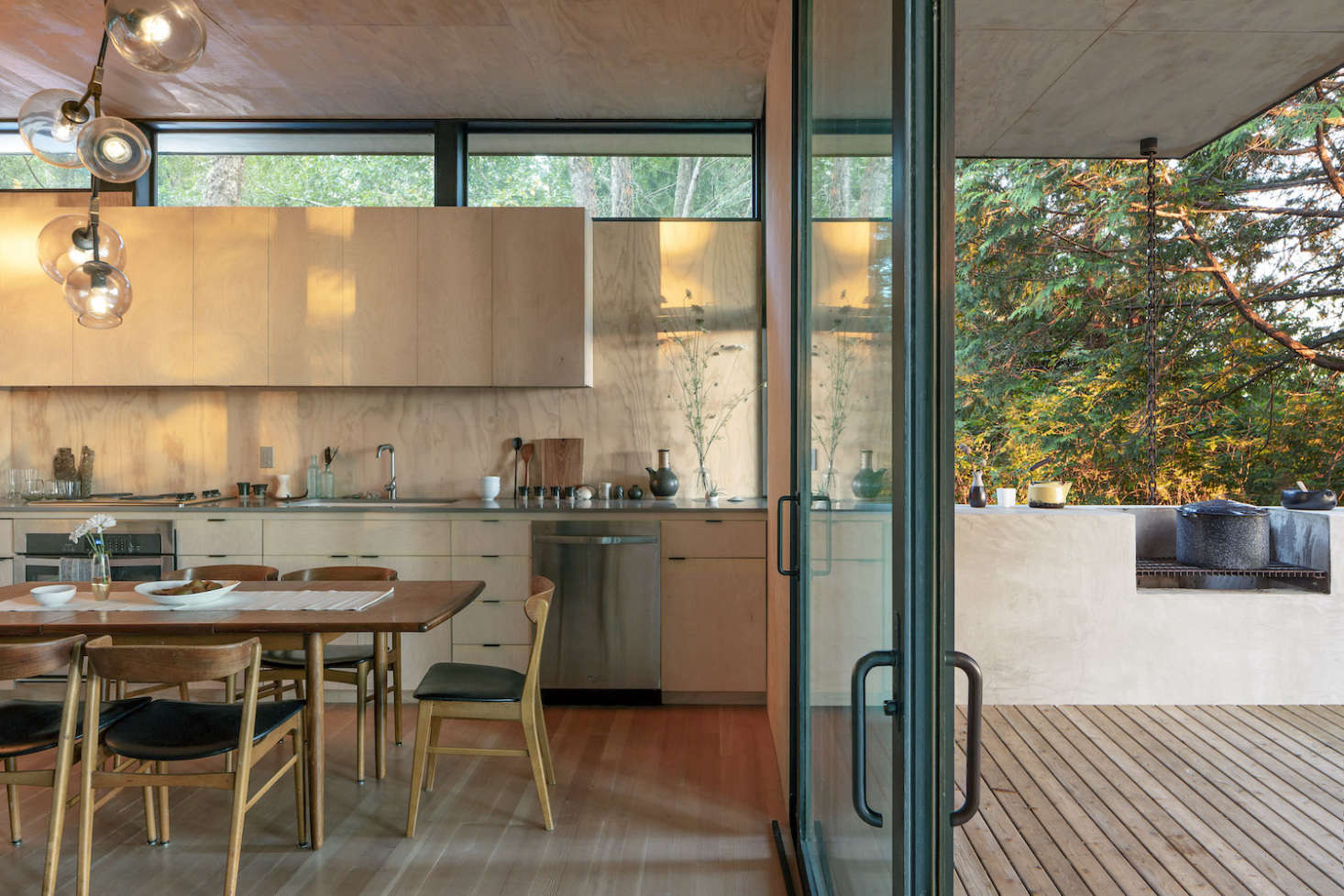 The concrete kitchen counter extends into an outdoor kitchen on the deck.