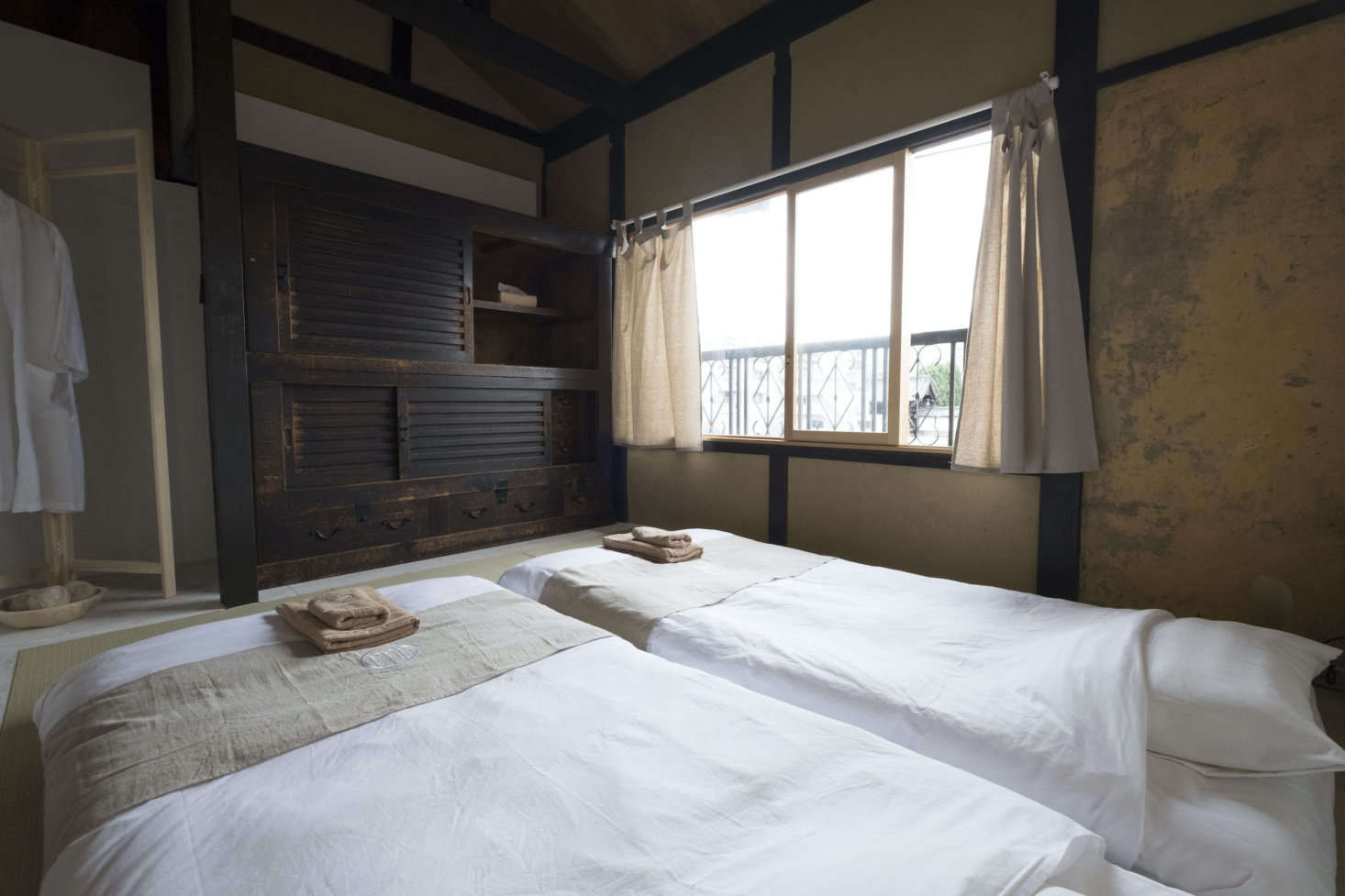 Two of the three bedrooms have twin futons on tatami mats. Temperature Studio in Taiwan designed the robes and towels, which also appear in the Day in Khaki shop. Stay tuned: a second historic house is in the process of being renovated as a rental.