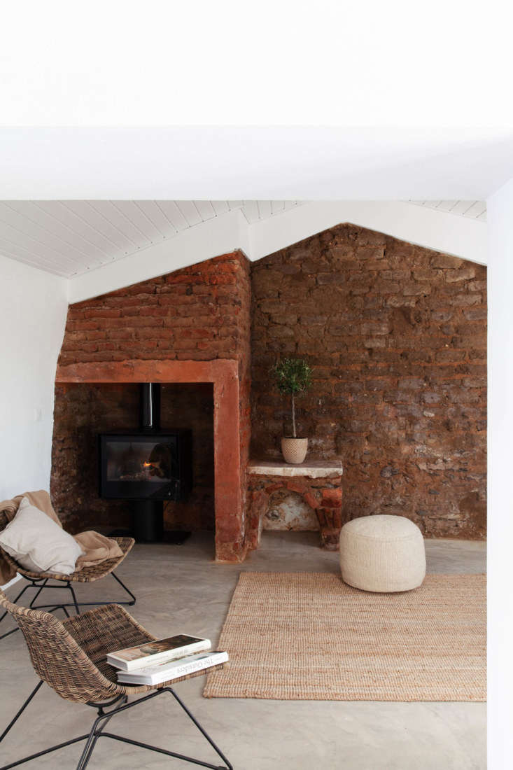 another lounge area has original exposed brick walls and a tucked away wood sto 25