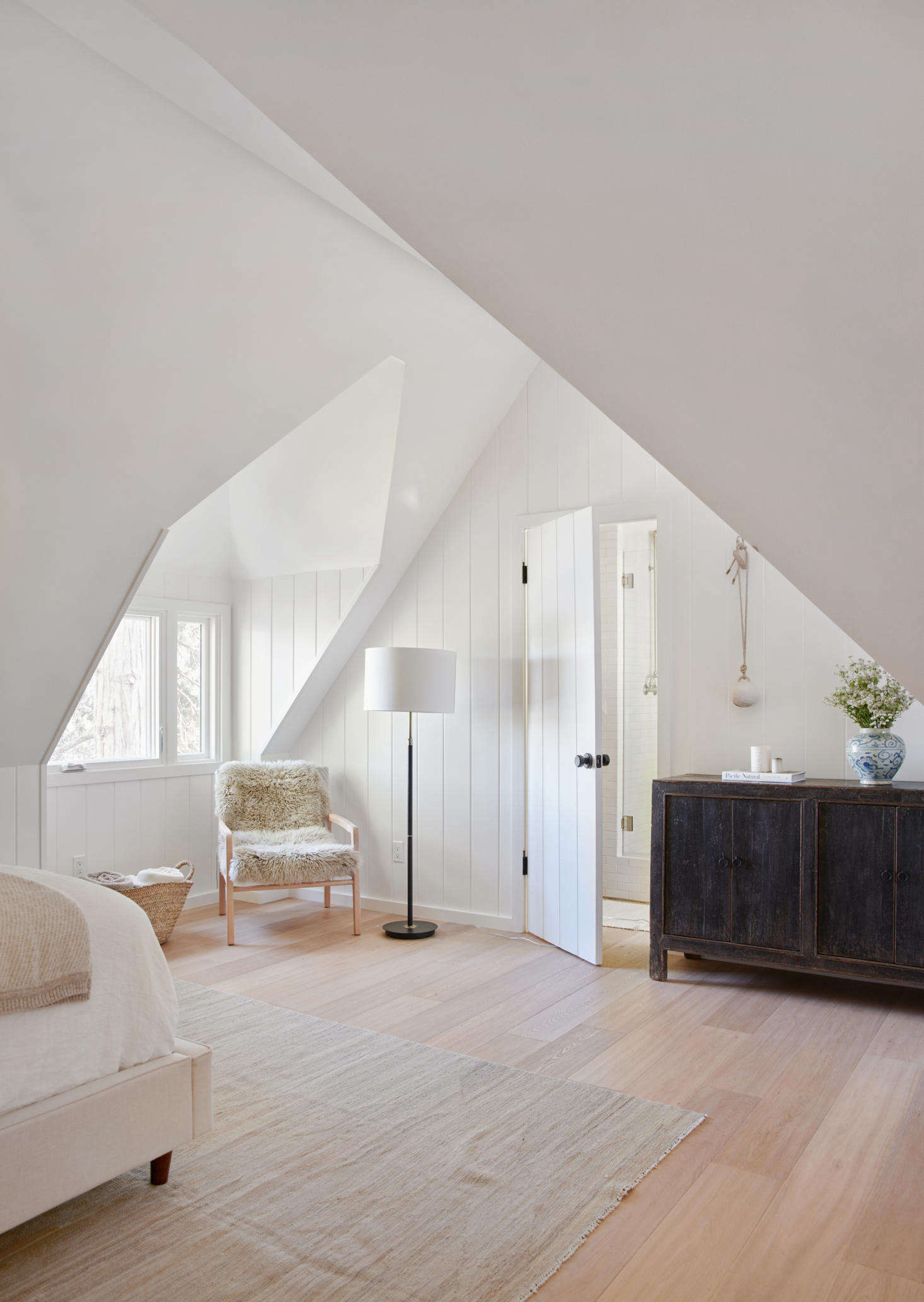 An airy upstairs bedroom has a reading nook with views of Lake Arrowhead.