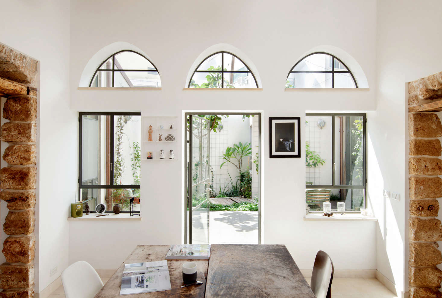 The house is petite—only 00 square feet—and square-shaped, with one corner cut off, all surrounding the original courtyard filled with fig trees and cyclamens, the architects say.