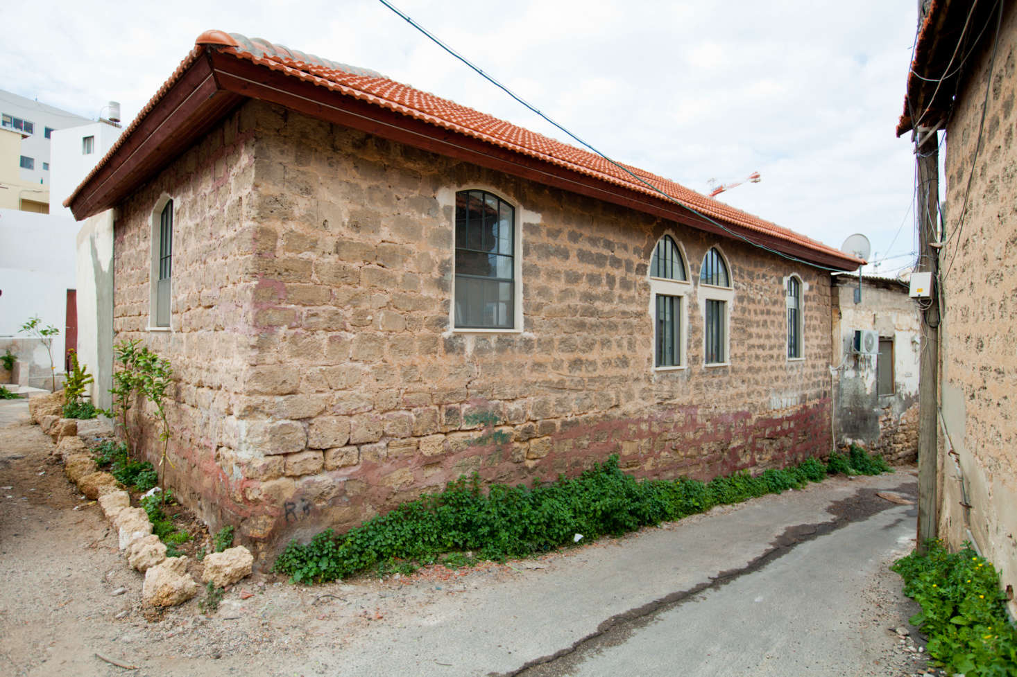The exterior of the little house, situated on a small lane.