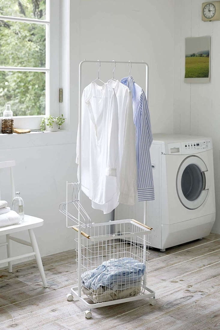 the yamazaki tosca tall laundry wagon, \$70, is a rolling clothes rack fitted w 33