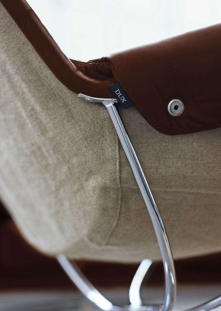 a detail of a jetson chair in leather with flax undersides, cushioned arms, and 19