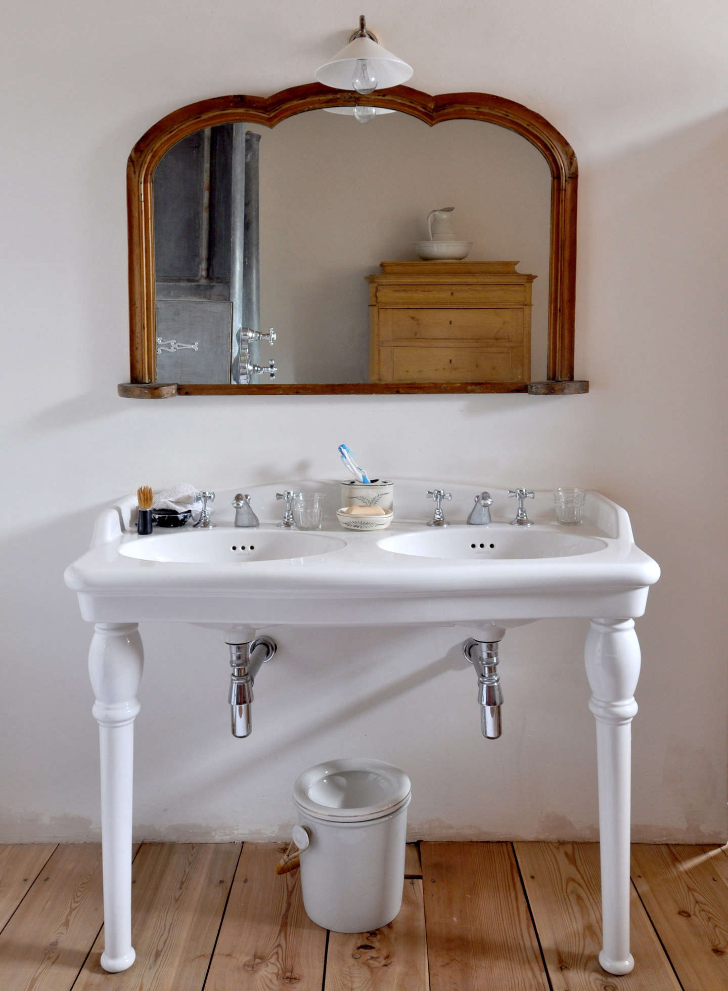 An antique double-sink vanity in the bath.