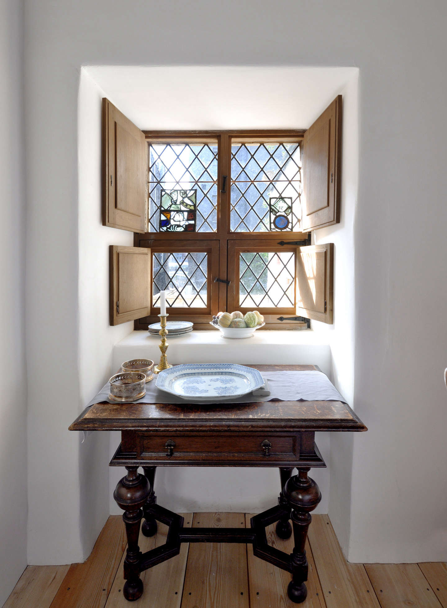The new leaded windows were handmade, sourced from Hungary. The bottom shutters are original to the building (because glass was once heavily taxed, many windows had half shutters that opened to the outside); the couple had upper shutters made to match.