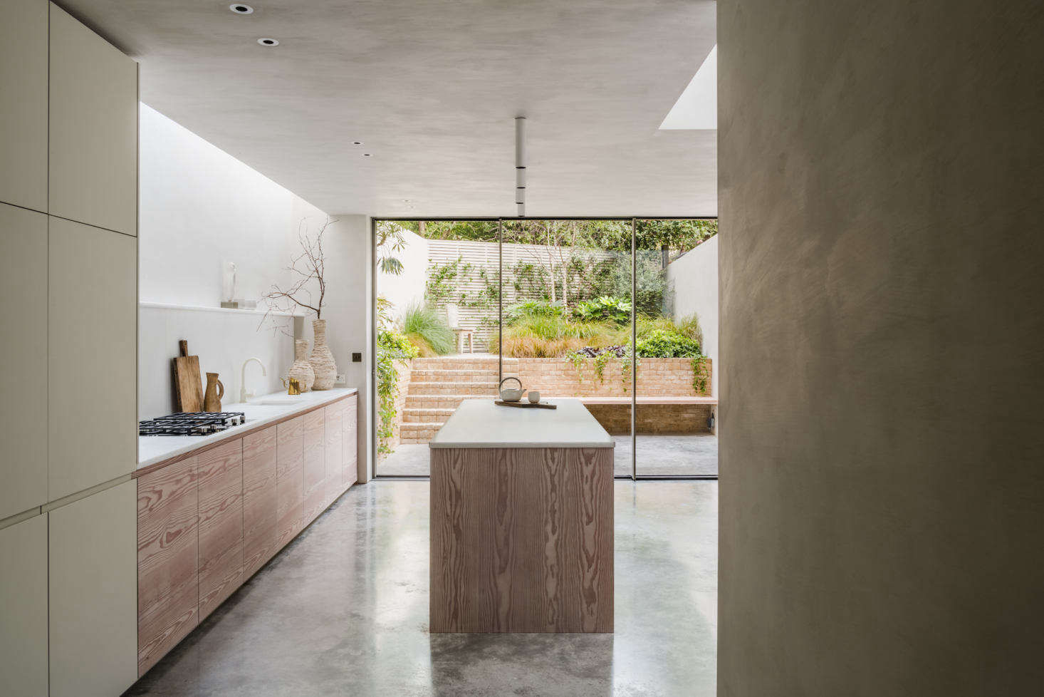 The basement level features polished-concrete flooring throughout and even extends seamlessly to the garden, just beyond the sliding doors in the kitchen.